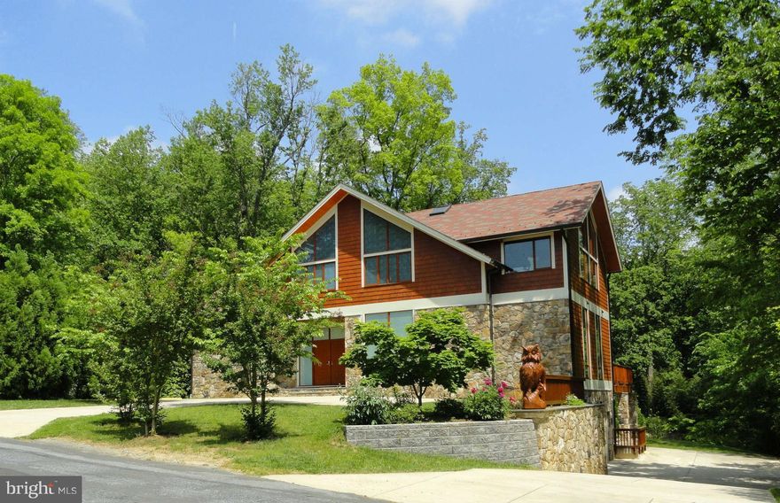 A Rare Deck House Masterpiece Beside Cabin John Park
Step into this extraordinary custom-built post-and-beam Deck House (Acorn Deck House) built in 2007 where soaring 27-foot cathedral ceilings and floor-to-ceiling windows create a breathtaking great room filled with natural light. The open layout and expansive rooms—over 7,000 square feet of living space—make this home perfect for both entertaining and everyday luxury.

Designed with timeless craftsmanship, the residence features exposed wood beams, Italian tile floors, cedar siding, and a man-made slate roof for enduring beauty. Modern conveniences include geothermal heating and cooling, a power generator, fire sprinkler system, front driveway for 4 cars and and a side 3-car garage with industrial-grade shelving. Outdoor living is just as impressive, with a large deck overlooking a private 19,250 sq. ft. lot, steps from the trails of Cabin John Creek Park.

Perfectly situated for those seeking the best of Bethesda, Potomac, Cabin John, and Carderock, this location offers unmatched convenience—just 15 minutes to downtown D.C. off-peak, with easy access to Virginia, Maryland, and both Dulles and Reagan airports (hard to believe, but there is no traffic light between this house and Dulles and Reagan airports).

Lovingly maintained by the original owners, this home is a rare find: a spacious, architecturally stunning retreat in one of the area’s most coveted settings.