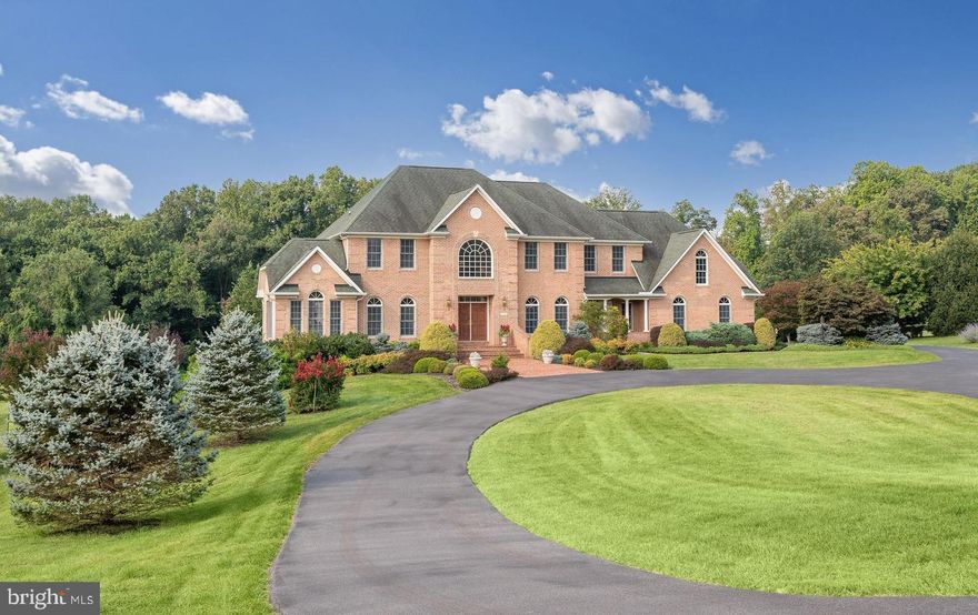 A remarkable all brick estate nestled in the most sought-after neighborhood in Centennial school district. Situated on 2.83 sprawling acres on a peaceful cul-de-sac lot, this stunning masterpiece built by Trinity Homes has every imaginable amenity.  Features include a paved circular driveway, professionally landscaped grounds, double pane Andersen windows with ultraviolet filter, six-inch walls with extra insulation, elegant lighting and more. 

Strong architectural detail and interior embellishments include soaring ceilings, intricate molding, beautiful hardwood floors throughout main level, a main level library with a private balcony, library built-ins, and adjacent full bath. This could become a flex bedroom room for main level living as needed.

A storied foyer flanked by living and dining formals combine with the adjacent sunroom to provide extended entertaining and relaxation. On the center axis, the gracious foyer unfolds into the family room featuring a central gas fireplace sided by built-ins and sconce lighting.  Purposeful design and an open floor plan define the heart of the home where the family room transitions seamlessly into a gorgeous eat-in kitchen. A commanding center island invites friends, family and foodies to gather around keeping company while the chef easily prepares and creates favorite recipes for all to share.   Stone counters, lovely tile backsplash, exposed wood beams, gas cooktop, double wall ovens, butler’s pantry, casual dining area, and an adjoining morning room with slider access to a paver dining patio provide endless living and entertaining options. The main level is completed by a spacious laundry center, walk-in closet, and mud room with a secondary entrance and porch.  

Opposite the butler’s pantry, a secondary private back stair rises to four upper-level bedrooms featuring an exceptional primary suite with a separate sitting room and private balcony. Dramatic cathedral ceilings and a tray ceiling with accent cove-lighting set the stage for luxury. Two walk-in closets, and a luxurious spa-like bath complete the upper level. 

Downstairs, a finished lower level offers an impressive recreation room with full daylight windows, fifth bedroom, dual entry bath, lots of storage, and walkout slider access to a rear patio and expansive lawn. Come home to spacious luxury and enjoy the sun set from the comfort of expansive hardscaping featuring a beautiful, tiered paver patio wrapped in stone garden walls, or from multiple private balconies.