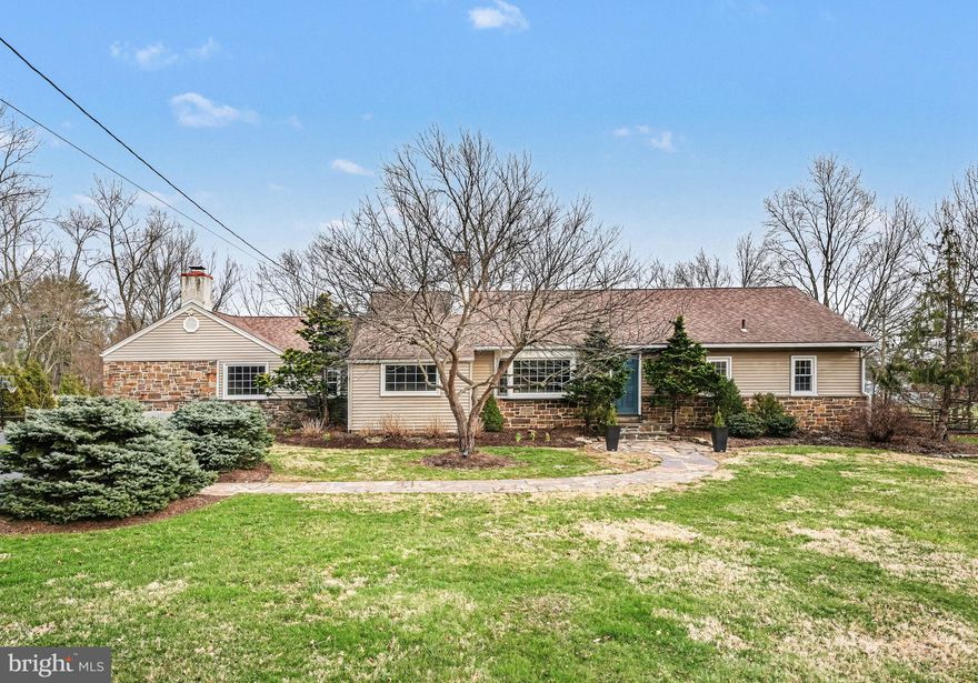 Welcome to 1408 Evans Road, a beautifully updated and thoughtfully expanded ranch home set on nearly an acre in desirable Lower Gwynedd Township. Offering 3 bedrooms with the potential for a 4th bedroom with its own full en-suite bath, and nearly 2,800 square feet of living space, this home blends timeless character with modern upgrades and unique custom features throughout. An attached two-car garage adds everyday convenience.

Step inside to a warm and inviting layout where original hardwood floors flow through much of the home. The spacious family room showcases hardwood flooring, recessed lighting, and a striking contemporary wood façade surrounding the fireplace—currently electric, but easily convertible back to wood-burning. Just beyond, a bright breakfast nook with recessed lighting connects to the beautifully updated kitchen, featuring shaker-style cabinetry, Corian countertops with under-mount sink, stainless appliances including a new refrigerator and electric range, skylight, and a large walk-in pantry with hidden “secret” storage. A charming breakfast bar window highlights the original butcher block, adding warmth and character to the space.

The kitchen opens seamlessly to a large screened-in porch with new ceiling fans and outdoor carpeting—perfect for relaxing or entertaining—with convenient access to the basement. Just beyond, a spacious deck with new TREX decking and elegant railings overlooks the fully fenced rear yard. A thoughtfully designed kitchen window service area with a marble bar creates easy indoor-outdoor flow, while a private rear gate opens directly to Gwynedd Mercy’s scenic fields and walking paths—an exceptional lifestyle feature rarely found.

Back inside, the dining room offers recessed lighting and classic hardwood flooring, flowing into a versatile front living space with a stunning stone fireplace, oversized bay window, and open connection to a flexible room currently used as a music room—ideal for a home office or additional sitting area.

The bedroom wing is thoughtfully arranged for both privacy and flexibility. The primary suite features hardwood floors, recessed lighting, two spacious closets, and an en-suite bath with stall shower. Two additional bedrooms are connected by a beautifully updated Jack-and-Jill bathroom with subway tile and penny tile flooring. A fourth flexible bedroom (currently used as a playroom) includes built-ins, hardwood floors, and access to its own full bath—perfect for guests, a private suite, or multigenerational living.

Additional highlights include a full walk-out basement with laundry, water softener system, two sump pumps with battery backups, and updated mechanicals including a new Carrier HVAC system (2025) and water heater (2021). The well was redrilled in 2018 (155 ft), and all plumbing has been replaced. Two electrical panels support both the original home and the family room addition.

From the charming front approach with sophisticated landscaping and a flagstone walkway, to the thoughtful details like hidden storage, unique architectural touches, and seamless indoor-outdoor living, this home offers a rare combination of space, functionality, and character—all within the highly regarded Wissahickon School District.