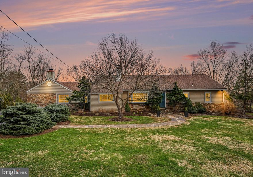 Welcome to 1408 Evans Road, a beautifully updated and thoughtfully expanded ranch home set on nearly an acre in desirable Lower Gwynedd Township. Offering 3 bedrooms with the potential for a 4th bedroom with its own full en-suite bath, and nearly 2,800 square feet of living space, this home blends timeless character with modern upgrades and unique custom features throughout. An attached two-car garage adds everyday convenience.

Step inside to a warm and inviting layout where original hardwood floors flow through much of the home. The spacious family room showcases hardwood flooring, recessed lighting, and a striking contemporary wood façade surrounding the fireplace—currently electric, but easily convertible back to wood-burning. Just beyond, a bright breakfast nook with recessed lighting connects to the beautifully updated kitchen, featuring shaker-style cabinetry, Corian countertops with under-mount sink, stainless appliances including a new refrigerator and electric range, skylight, and a large walk-in pantry with hidden “secret” storage. A charming breakfast bar window highlights the original butcher block, adding warmth and character to the space.

The kitchen opens seamlessly to a large screened-in porch with new ceiling fans and outdoor carpeting—perfect for relaxing or entertaining—with convenient access to the basement. Just beyond, a spacious deck with new TREX decking and elegant railings overlooks the fully fenced rear yard. A thoughtfully designed kitchen window service area with a marble bar creates easy indoor-outdoor flow, while a private rear gate opens directly to Gwynedd Mercy’s scenic fields and walking paths—an exceptional lifestyle feature rarely found.

Back inside, the dining room offers recessed lighting and classic hardwood flooring, flowing into a versatile front living space with a stunning stone fireplace, oversized bay window, and open connection to a flexible room currently used as a music room—ideal for a home office or additional sitting area.

The bedroom wing is thoughtfully arranged for both privacy and flexibility. The primary suite features hardwood floors, recessed lighting, two spacious closets, and an en-suite bath with stall shower. Two additional bedrooms are connected by a beautifully updated Jack-and-Jill bathroom with subway tile and penny tile flooring. A fourth flexible bedroom (currently used as a playroom) includes built-ins, hardwood floors, and access to its own full bath—perfect for guests, a private suite, or multigenerational living.

Additional highlights include a full walk-out basement with laundry, water softener system, two sump pumps with battery backups, and updated mechanicals including a new Carrier HVAC system (2025) and water heater (2021). The well was redrilled in 2018 (155 ft), and all plumbing has been replaced. Two electrical panels support both the original home and the family room addition.

From the charming front approach with sophisticated landscaping and a flagstone walkway, to the thoughtful details like hidden storage, unique architectural touches, and seamless indoor-outdoor living, this home offers a rare combination of space, functionality, and character—all within the highly regarded Wissahickon School District.