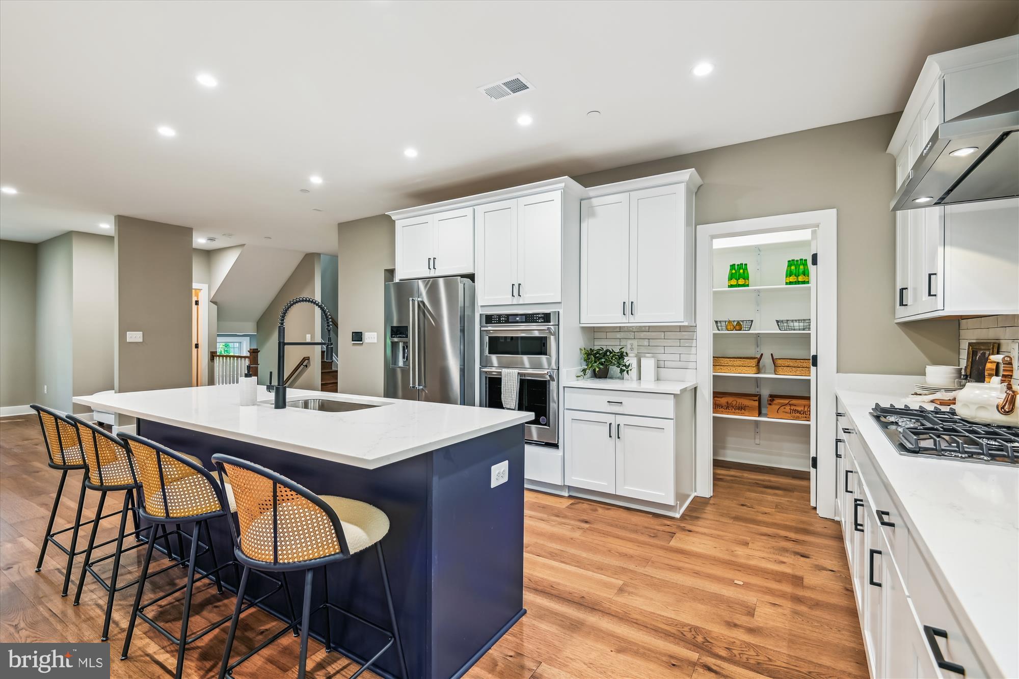 Move-in ready new construction from acclaimed local builder, Sturbridge Homes. This spectacular home offers over 5,000 square feet of finished space in the heart of Annapolis's Homewood neighborhood, close to all of the entertainment and enjoyment available in our historic town. Located near the new Annapolis Public Library, Maryland Hall, Annapolis Town Center, and the Naval Academy Stadium, this home is situated for you to enjoy the best of in-town life, yet relax in a tree-lined neighborhood environment.
This home is excellently upgraded with 9-foot ceilings on all three levels, quartz countertops, ceramic tile, stainless appliances, and hardwood flooring throughout the 1st floor, owner’s suite, and stair/hallways. The primary suite is a luxurious oasis with plenty of space to enjoy, a huge customizable walk-in closet, and a spectacular multi-head walk-in shower. The lower level features a separate entrance, a bedroom and a full bathroom, and a large wet bar with a beverage refrigerator, making it perfect for entertaining guests, caregiving, or multi-generational living. The builder has included many thoughtful touches, like decorative moulding, wood closet and pantry shelving, and a mudroom bench and organizer. The front porch is a perfect spot to savor your morning coffee, and the backyard offers endless possibilities. The home comes with a $15,000 closing cost credit (conditions apply), a $10,000 credit toward closet customization, a package of smart home features, and a 10-year limited warranty. Enjoy the low-maintenance lifestyle of a new construction home for many years to come!