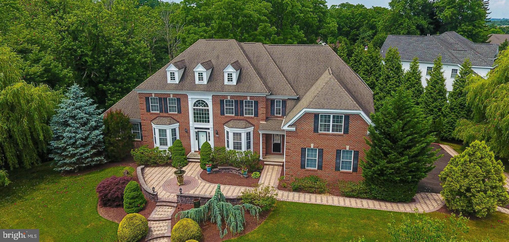 Welcome to the Woods of Northampton — a prestigious neighborhood known for its tree-lined streets and generous yards. Perched gracefully on an elevated 1.4-acre corner site, this property offers commanding views and a sense of serene seclusion. The raised position enhances natural light and airflow throughout the home. This stunning residence sits on a private 1.4-acre corner lot offering the perfect blend of relaxation and privacy. Step inside to a two-story foyer featuring a grand curved oak staircase that sets the tone for the rest of the home. Enjoy the charm and warmth of the formal living room and dining room, featuring well-appointed details, tray ceilings, and hardwood flooring. The conservatory is a true showstopper, bathed in natural light from walls of windows and finished with sleek slate flooring. It’s the ideal space to relax, unwind, or claim as your office. Spacious and private for the perfect space to work as well as relax. The heart of the home is the well-designed kitchen with ample Cherry wood cabinetry, convenient pull-out drawers on all lower cabinets, under-cabinet lighting, granite counters, and centered around an enormous island that easily accommodates meal prep, casual dining, and lively conversations. The coffee bar and walk-in pantry complete the kitchen. Enjoy your morning coffee sitting in the sunlit breakfast room overlooking the backyard. Or go out onto the deck for some quiet time. The kitchen opens seamlessly to a stunning great room with a soaring 18-foot ceiling, hand-scraped maple hardwood flooring, oversized windows, and a cozy gas fireplace. Dual staircases offer both formal and casual access to the 2nd floor. A convenient secondary staircase from the great room rear leads to the second level, where you'll find a family room loft offering plenty of room to lounge. Each bedroom offers comfort and ample closet space. One bedroom has a full en suite, and another has an attached bathroom. The primary suite is a true retreat, featuring rich cherry mahogany hardwood flooring, a tray ceiling, a dressing area, and a custom walk-in closet large enough for two wardrobes. The en-suite bathroom is pure luxury—finished with marble floors, dual vanities repurposed from antique dressers (complete with built-in drawer outlets), a 5’ x 5’ walk-in shower, oversized jacuzzi tub, water closet, a cathedral ceiling, and refined details throughout. An oak staircase from the great room leads you to the incredible 2500 sq ft finished basement —a space that truly takes this home to the next level—plenty of space for a gym, game room, and entertainment space with a kitchenette. A private bedroom with atrium doors and a walk-in closet hidden behind a custom Murphy door designed as a bookcase is a fun and functional touch that guests will love. The home theatre is well designed and perfect for movie nights and game day gatherings. The walk-out basement and full bathroom complete the lower level. Whether you're hosting friends, housing guests, or need your own escape—you’ll find it all here. The private backyard features an expansive blue flagstone patio – perfect for entertaining or unwinding in your outdoor oasis. This is more than a home. It’s a lifestyle upgrade waiting to happen. This property is not located in a flood zone, nor is it near a flood zone. The sellers never had any flooding.