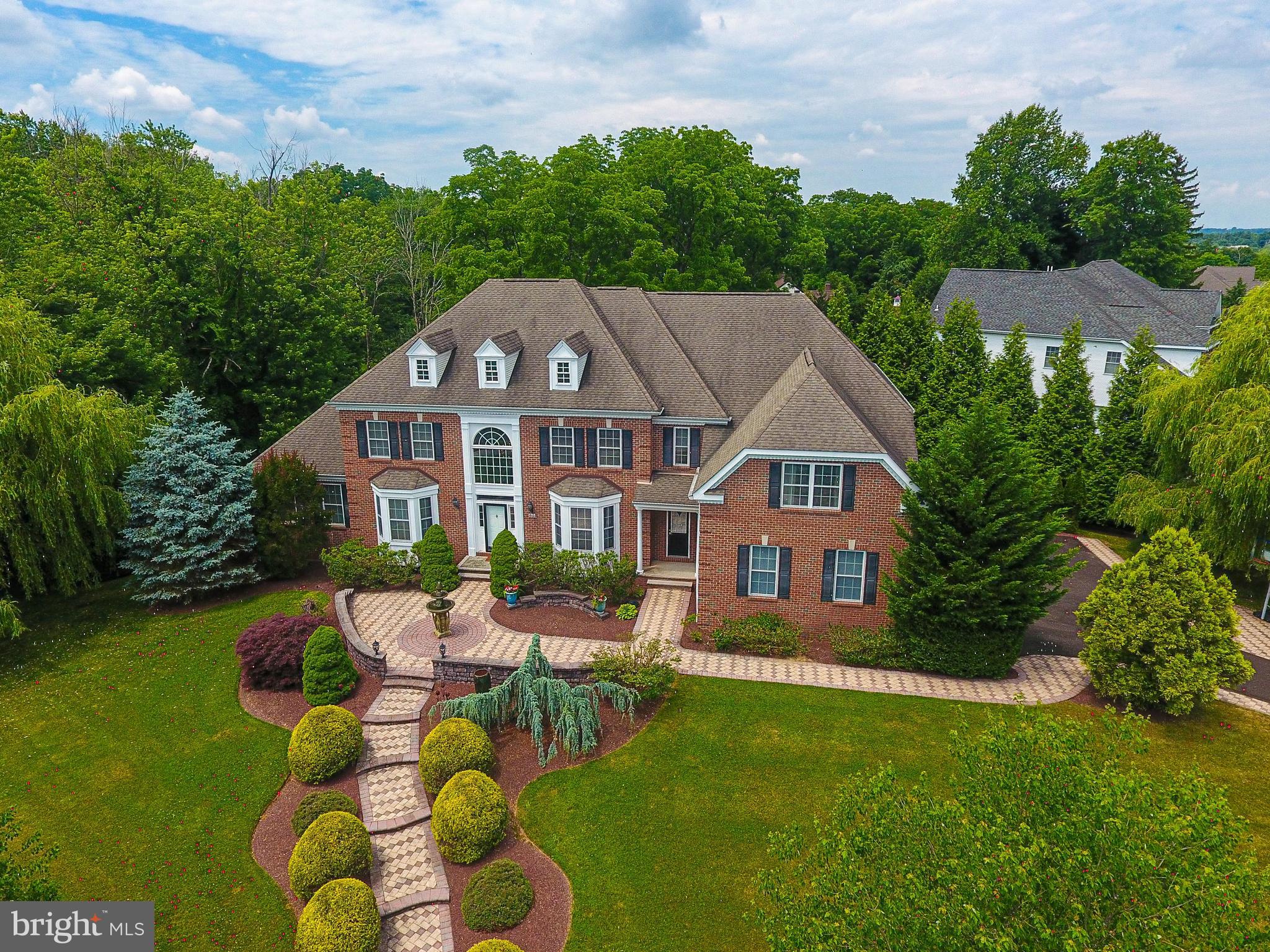 Welcome to the Woods of Northampton — a prestigious neighborhood known for its tree-lined streets and generous yards. This stunning residence sits on a private 1.4-acre corner lot offering the perfect blend of relaxation and privacy. Step inside to a two-story foyer featuring a grand curved oak staircase that sets the tone for the rest of the home. Enjoy the charm and warmth of the formal living room and dining room with well-appointed features, tray ceilings, and hardwood flooring. The conservatory is a true showstopper, bathed in natural light from walls of windows and finished with sleek slate flooring. It’s the ideal space to relax, unwind, or claim as your office. Spacious and private for the perfect space to work as well as relax. The heart of the home is the well-designed kitchen with ample solid wood cabinetry, convenient pull-out drawers on all lower cabinets, under-cabinet lighting, granite counters, and centered around an enormous island that easily accommodates meal prep, casual dining, and lively conversations. The coffee bar and walk-in pantry complete the kitchen. Enjoy your morning coffee sitting in the sunlit breakfast room overlooking the backyard. Or go out onto the deck for some quiet time. The kitchen opens seamlessly to a stunning great room with a soaring 18-foot ceiling, hand-scraped maple hardwood flooring, oversized windows, and a cozy gas fireplace. Dual staircases offer both formal and casual access to the 2nd floor. A convenient secondary staircase from the great room rear leads to the second level, where you'll find a family room loft offering plenty of room to lounge. Each bedroom offers comfort and ample closet space. One bedroom has a full en suite, and another has an attached bathroom. The primary suite is a true retreat, featuring rich cherry mahogany hardwood flooring, a tray ceiling, a dressing area, and a custom walk-in closet large enough for two wardrobes. The en-suite bathroom is pure luxury—finished with marble floors, dual vanities repurposed from antique dressers (complete with built-in drawer outlets), a 5’ x 5’ walk-in shower, oversized jacuzzi tub, water closet, a cathedral ceiling, and refined details throughout. An oak staircase from the great room leads you to the incredible 2500 sq ft finished basement —a space that truly takes this home to the next level—plenty of space for a gym, game room, and entertainment space with a kitchenette. A private bedroom with atrium doors and a walk-in closet hidden behind a custom Murphy door designed as a bookcase is a fun and functional touch that guests will love. The home theatre is well designed and perfect for movie nights and game day gatherings. The walk-out basement and full bathroom complete the lower level. Whether you're hosting friends, housing guests, or need your own escape—you’ll find it all here. The private backyard features an expansive blue flagstone patio – perfect for entertaining or unwinding in your outdoor oasis. This is more than a home. It’s a lifestyle upgrade waiting to happen.