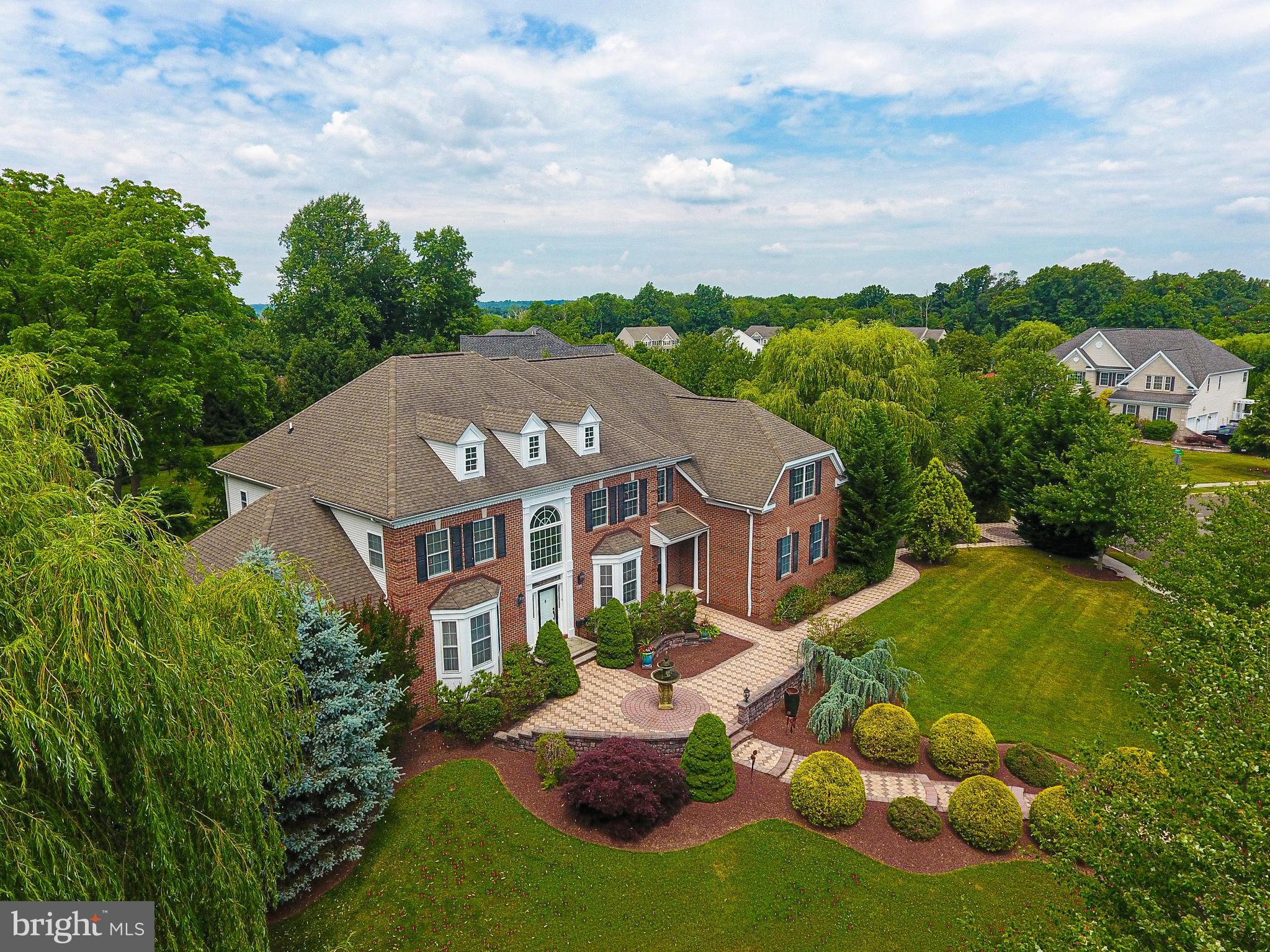 Welcome to the Woods of Northampton — a prestigious neighborhood known for its tree-lined streets and generous yards. Perched gracefully on an elevated 1.4-acre corner site, this property offers commanding views and a sense of serene seclusion. The raised position enhances natural light and airflow throughout the home. This stunning residence sits on a private 1.4-acre corner lot offering the perfect blend of relaxation and privacy. Step inside to a two-story foyer featuring a grand curved oak staircase that sets the tone for the rest of the home. Enjoy the charm and warmth of the formal living room and dining room, featuring well-appointed details, tray ceilings, and hardwood flooring. The conservatory is a true showstopper, bathed in natural light from walls of windows and finished with sleek slate flooring. It’s the ideal space to relax, unwind, or claim as your office. Spacious and private for the perfect space to work as well as relax. The heart of the home is the well-designed kitchen with ample Cherry wood cabinetry, convenient pull-out drawers on all lower cabinets, under-cabinet lighting, granite counters, and centered around an enormous island that easily accommodates meal prep, casual dining, and lively conversations. The coffee bar and walk-in pantry complete the kitchen. Enjoy your morning coffee sitting in the sunlit breakfast room overlooking the backyard. Or go out onto the deck for some quiet time. The kitchen opens seamlessly to a stunning great room with a soaring 18-foot ceiling, hand-scraped maple hardwood flooring, oversized windows, and a cozy gas fireplace. Dual staircases offer both formal and casual access to the 2nd floor. A convenient secondary staircase from the great room rear leads to the second level, where you'll find a family room loft offering plenty of room to lounge. Each bedroom offers comfort and ample closet space. One bedroom has a full en suite, and another has an attached bathroom. The primary suite is a true retreat, featuring rich cherry mahogany hardwood flooring, a tray ceiling, a dressing area, and a custom walk-in closet large enough for two wardrobes. The en-suite bathroom is pure luxury—finished with marble floors, dual vanities repurposed from antique dressers (complete with built-in drawer outlets), a 5’ x 5’ walk-in shower, oversized jacuzzi tub, water closet, a cathedral ceiling, and refined details throughout. An oak staircase from the great room leads you to the incredible 2500 sq ft finished basement —a space that truly takes this home to the next level—plenty of space for a gym, game room, and entertainment space with a kitchenette. A private bedroom with atrium doors and a walk-in closet hidden behind a custom Murphy door designed as a bookcase is a fun and functional touch that guests will love. The home theatre is well designed and perfect for movie nights and game day gatherings. The walk-out basement and full bathroom complete the lower level. Whether you're hosting friends, housing guests, or need your own escape—you’ll find it all here. The private backyard features an expansive blue flagstone patio – perfect for entertaining or unwinding in your outdoor oasis. This is more than a home. It’s a lifestyle upgrade waiting to happen. This property is not located in a flood zone, nor is it near a flood zone. The sellers never had any flooding.