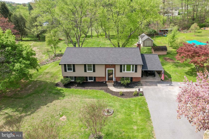 *Welcome to this beautiful 4BR 2.5 Bath home nestled on a flat 0.62-acre lot that backs to mature trees*Exterior features new roof, new rear yard, new gutters, oversized driveway, carport, spacious rear deck, rear paver patio, large storage shed with electric, another storage shed, & a new septic installed in 2025*Inside main level has real hardwood floors, cozy living room, a dining area that opens to an updated kitchen with stainless appliances, breakfast bar, & granite counter tops*The primary bedroom also features a primary half bath*Two additional bedrooms on the main level include hardwood floors, ceiling fans, & a fully remodeled full bath (2024)*The walkout lower level includes has another bedroom, an office, a full bath, a family room with a brick hearth & wood stove, a laundry room, & additional storage*The Amish-built shed in the backyard is insulated, has flooring, & is equipped with electricity - ideal for all of your hobby needs*Other updates include new siding (2013), outside HVAC unit (2021), interior unit blower & oil pumps (2020), well pump (within the last 6 years), carport & asphalt driveway (2022)*High end efficient lighting & blue tooth speakers recently added throughout as well as updates to the fireplace*Truly move in ready*