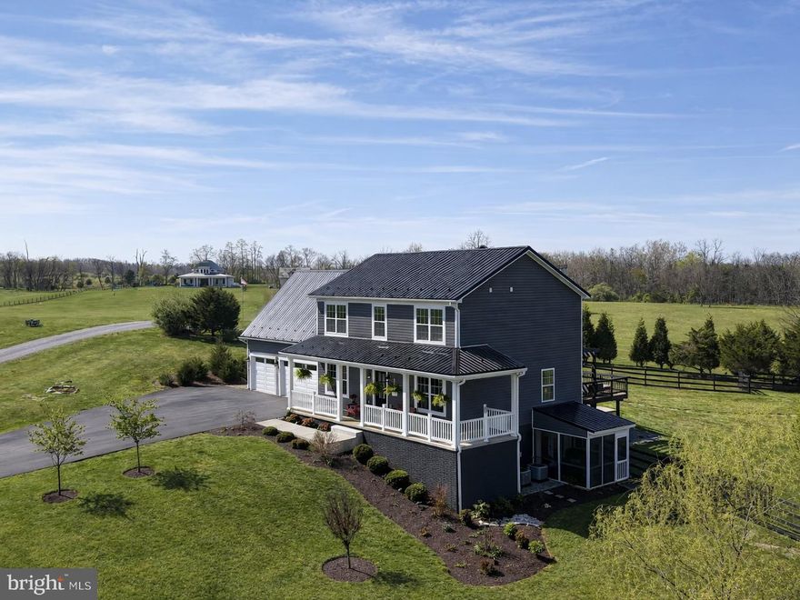 This east-facing 4-bedroom, 3.5-bath modern farmhouse with wrap-around porch and attached 3-car garage, built in 2016 sits on just over four fully usable acres. Its just minutes from historic Shepherdstown, recently named a USA Today Top 10 Historic Small Town.  It is a turn-key farmette (complete with chickens and a chicken coop!) offering a rare blend of lifestyle, flexibility, and infrastructure already in place.

Inside, the home features over 3600 square feet of bright, connected living space (2700 above grade) with a clean, updated feel throughout—plus a fully renovated, approximately 900-square-foot walk-out lower-level mother-in-law suite completed in 2023. Nearly every room captures expansive views and the private lot allows you to enjoy both sunrise and sunset with the curtains open.

The living room is anchored by a statement fireplace wall, wainscoting and shiplap accents, and is complemented by on-trend lighting and LVP flooring throughout. The updated, modern kitchen features quartz countertops, stainless steel appliances plus range hood, and a seamless flow into both the informal dining area and formal dining room. French doors lead to an expansive Trex deck with a custom pergola, overlooking the greenhouse, fire pit, and the sweeping sunset views.

Upstairs, you’ll find three well-sized bedrooms. The primary suite serves as a true retreat, complete with a walk-in closet and a spacious en suite bath with heated floors and a glass-enclosed walk-in shower. A separate dressing room sits just adjacent, along with the conveniently located upper-level laundry. Two additional bedrooms share a hall bath with a tub/shower combination, while a 500-square-foot bonus room at the end of the hallway offers flexible space for a media room, playroom, or craft room.

The fully finished lower level provides a private, independent living setup with a kitchenette, living and dining areas boasting custom built-in bookcases, a bedroom with two closets (including a large walk-in), a full bath, and direct access to the screened-in patio—ideal for multigenerational living, extended guests, or short term rental. This level also includes a second laundry area and houses the reverse osmosis water purification, UV light  and water softening systems.

Outdoor living is fully established with an elevated deck, pergola, multiple seating areas, and a dedicated fire pit space. The rear yard is fenced with freshly painted black paddock fencing and includes a fenced raised-bed garden, fruit trees, a greenhouse on a cement foundation, and the chicken coop —creating a true turn-key farmette experience.  Horses are allowed - for more info, just reach out!

Additional features include a 1,500+ square foot metal outbuilding suitable for a workshop, storage, or hobby space, as well as a John Deere zero-turn riding mower (purchased new in 2022)—which conveys with a full-price (or better) offer.

Recent upgrades include: the greenhouse and the chicken coop (both on concrete foundations); metal roofs on both the main house and the outbuilding; the Trex deck and pergola; the whole-house propane-fueled Generac generator; the water UV light and reverse osmosis purification systems; as well as the aforementioned lower level suite as well as the screened-in patio and the driveway was paved to perfection.

Well and septic records are attached to the listing. Buyers can feel free to reach out directly to obtain those or any other listing documents. Septic was last pumped in May 2025.  Sellers currently use Apple Valley for waste removal. Internet is through T-Mobile plus there's a Direct TV dish installed. The 500-gallon propane tank (full) is leased and serviced through Southern States Energy.  Generator is serviced through Todd Electric.  Floor plans available.  

Public, catered and fabulous open houses on Saturday 4/18 and Sunday 4/19.  Private showings start Monday 4/20.  Staging and photography by Honey House.