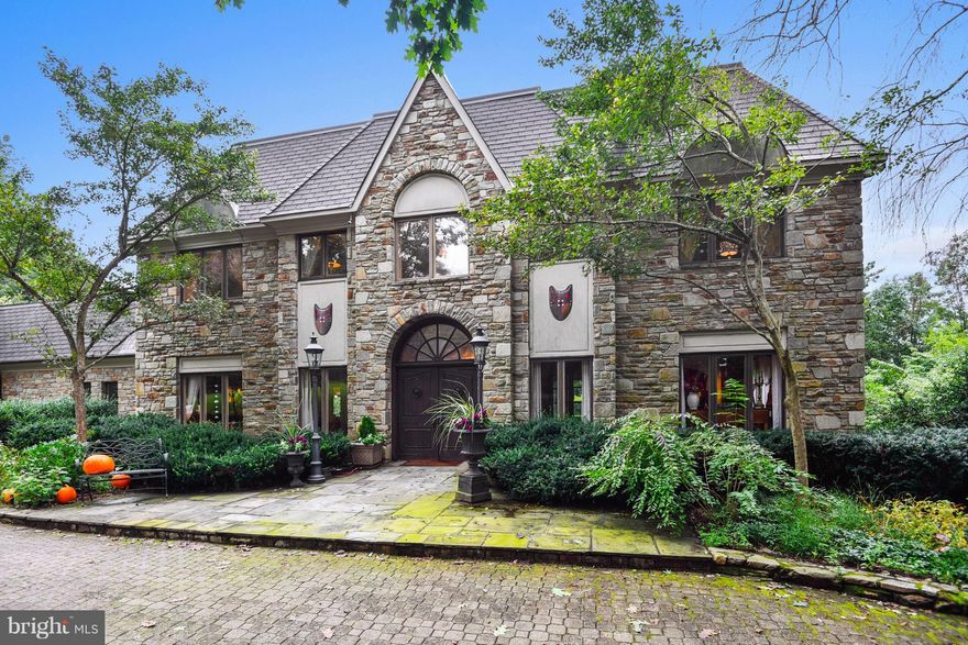 Significant price reduction! Secluded & spectacular stone manor home w/gated entrance on 4+ acres of privacy. This 4BR 3/3BA features a grand foyer w/suspended upper hall, gourmet KIT covered in granite, formal DR, sun-drenched LR & finished LL with full bar & gym. Extravagant MBR suite w/ FP & balcony. Multiple porches, amazing salt water pool, stone walls, courtyard & views complete the picture.