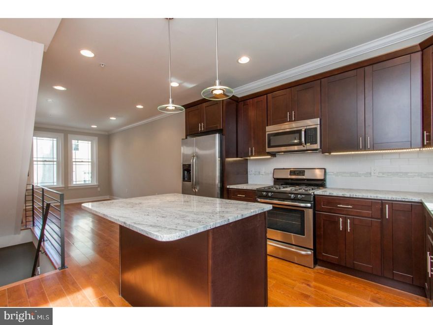 A gorgeous new construction home you need to see! 7 out of 10 home development already sold, this home is right next to the brand new Ralph Brooks Park and a block from the community garden. Found on a quaint residential street, enter and discover desirable details throughout, including hardwood flooring, corner beaded walls, recessed lighting and large windows for plenty of natural light. The home features a large living room with built in speakers and an open dining room showcasing any furniture arrangement to suit your taste. Continue into the kitchen, complete with granite counters, stainless steel appliances, tiled backsplash and access to a concrete rear yard: perfect for lounging on sunny days! The second floor features two light filled bedrooms with ample closet space, and a full tiled bath with tub and shower. The third floor reveals a fabulous master suite with walk in closet, trey ceiling with lighting, a full bath with stall shower with a frameless glass enclosure. Be sure to stop by the 3rd floor's wet bar before heading up to the full sized roofdeck with built in speakers and tons of builtin lightiing, just the spot to sit back and admire the fantastic view. Still not enough room for you? Check out the full finished basement, with full tiled bath for your comfort & convenience. With a 10 year tax abatement, this is one you definitely don't want to miss! Hurry to choose whatever finishes have not been completed yet, home is currently under construction.