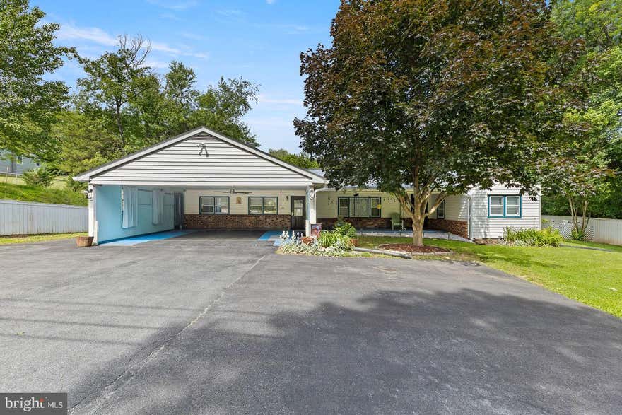 Price Improvement, Motivated Seller. Harpers Ferry West Virginia, Where the Potomac River and Shenandoah Rivers meet!  This home was purchased by the current owner as a forever home, but now life is moving the seller in a different direction! The home is set up for an Air B and B, for part time or full time living! The home is a well built home, constructed in 1968.  This 3 bedroom, 1 bath home boasts some original characteristics with many updates.
The exterior of the home is inviting with a cozy front covered front porch, large 2 car carport and 6 space paved driveway for additional parking space.  There are beautiful trees and newly landscaped area with flowers and annual plants decorating the yard.  Entering in the home, you'll find a traditional style layout with a open living room with hardwood floors,  kitchen with original hard oak kitchen cabinets and vintage countertops. Moving throughout the home, you'll also find a full bathroom with tub/shower.  There are 3 full bedroom, with hardwood flooring, one bedroom holds the laundry area.  Moving to the basement- Full unfinished with a dividing wall used as a recreation room.  All utilities are in the basement, panel box, generator box, newer water heater, oil tank, furnace, water filter. The backyard is a relaxing space with a stone patio, beautiful willow trees, flowers and a partially fenced in space. The property include a small detached garage for machinery and workspace, additionally there are 2 other buildings. 1 is a potting/storage shed, the other is a small "cabin" finished as a small guest space. (no running water) but has electric. The beauty of the Harpers Ferry area shows with the view from the back yard.  Relax and enjoy in the home as a full time residence or part time vacation spot. No HOA. Many updates on this home include, updated electrical, New Roof as of 2025, New Wood stove, Generator, Newer Hot Water heater, and much more. Ask listing agent for documentation of all updates. 2 lots one is .57 and the other .26 making a total of .83. These 2 lots are deeded seperately and being sold together. The Well and septic documents are in paperwork Septic approved for 3 bedrooms.