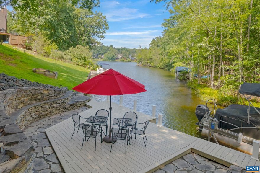 WATERFRONT with Privacy! This fabulous home is situated in a cul-de-sac with a reserve area behind it. One Level Living at its best. Large Foyer with Side lights at door. Formal Dining room, *Kitchen features - Gorgeous Cherry cabinets, Glass front with Undercabinet lighting, Recessed lights, Solid Surface counters and backsplash, Kitchen Island, Pantry, Stainless Steel appliances, *Laundry Room w/Washer & Dryer, matching cabinets to Kitchen *Open floor plan, Recessed Cabinets above Fireplace in Great Room, Gas Log Fireplace, Split Bedroom design, Recessed lighting thru-out, Hardwood Floors and Ceramic tile, Cathedral ceiling, Chair-rail, Crown moulding, * Primary Bedroom W/WATERVIEWS, Attached bath, Walk-in closet, Double Vanities, Jetted tub W/separate shower. All 4 bedrooms feature WATERVIEWS, *Stunning two-level rear decks the length of the home, lower screened deck, W/waterproof ceiling.  *Lower level, Family room, 2 Bedrooms, Entertainment area, Sliding door to Lower screened deck, Extra storage, Magnificent Composite Dock and Deck, W/Kayak dock area, Flagstone Walkways, Stone retaining walls, Plus Water and Electric at the Dock. Beautifully Landscaped with Magnolia, Plum and Crepe Myrtle trees. Asphalt Driveway.,Cherry Cabinets,Glass Front Cabinets,Solid Surface Counter,Fireplace in Great Room