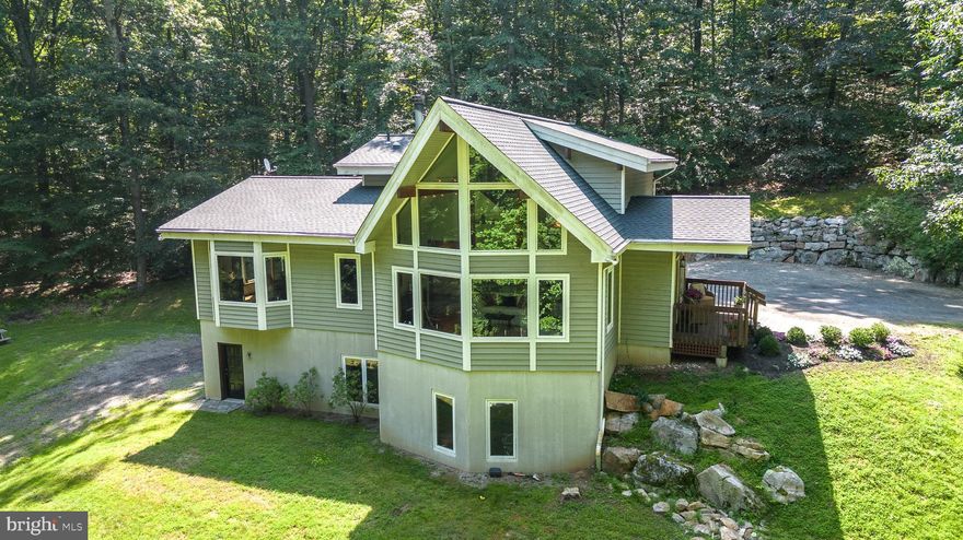 Welcome to 4943 Upper Mountain Rd., New Hope, PA.  Rarely does a property of such incomparable serenity and beauty become available.  Located on 6 private acres, at the base of Buckingham Mountain this Lindal Home has been lovingly cared for and updated.  The quiet strength of the Architectural Grade Douglas Fir Glu-Lam Posts & Beams is apparent as you enter the home and are greeted by an amazing Great Room with a wall of glass.  The Main Floor has a Full Bath and a Bedroom, the Kitchen and Dining area, Sitting/Media area and the Great Room.  A spacious Mud Room/Laundry Room is on the Main Floor also.  The custom Kitchen cabinets are beautiful.  The open-floor-plan concept is used here.  The Primary Bedroom is on the Second Floor along with a walk-in Closet and Full Bath.  A sliding glass door there opens to a deck/balcony, the perfect spot to see the sunrise and have your morning coffee.  A full Walk-Out Daylight Basement houses the Garage, an Office/Workout area, a Family Room and the Utility Room.  There is also a full Bath on that level.  A new High Efficiency HVAC has just been installed along with a new roof.  Check out the Virtual Tour.  Located in Central Bucks County this home is convenient to shopping and restaurants but cloistered from the world.  Let this be your Sanctuary.  Come visit soon!