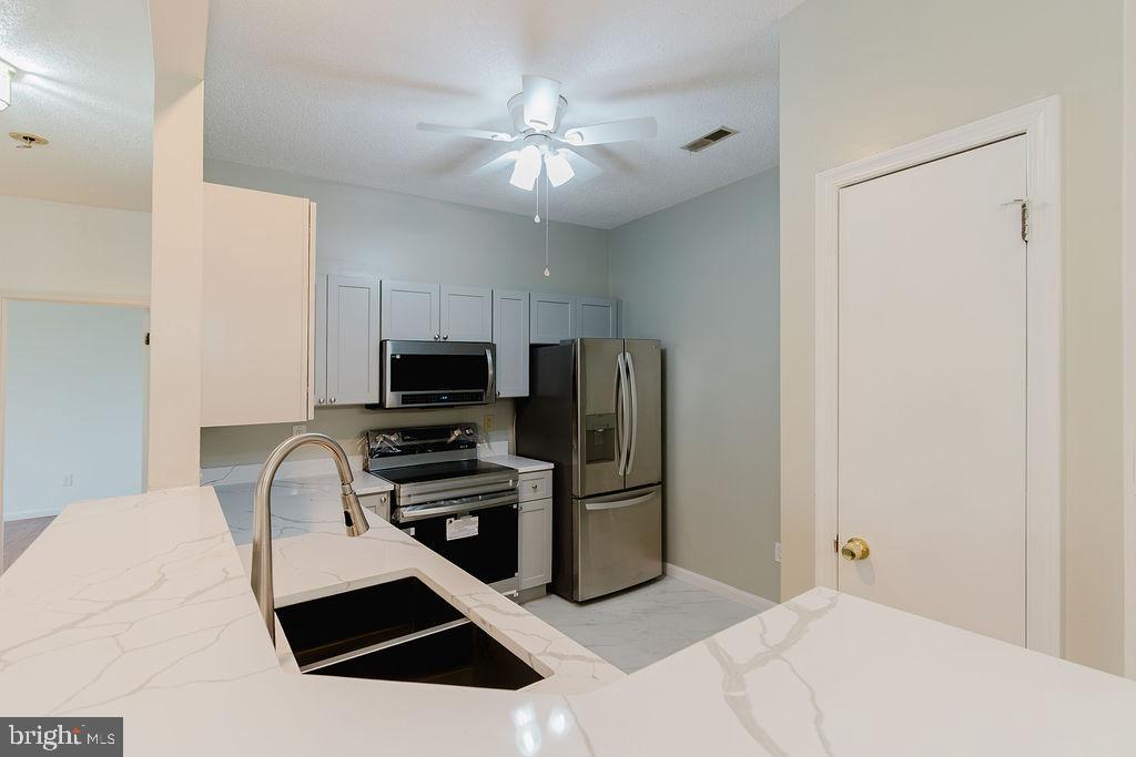 WOW! Don’t miss this beautifully updated 2-bedroom, 1-bath condo in the heart of Windsor Mill! Freshly painted and move-in ready, this second-floor unit features a fully renovated bathroom with new flooring, tub, and shower surrounds, updated vanities, modern lighting, fixtures, and a brand-new toilet.
The stylish kitchen is a dream with quartz countertops, soft-close cabinets, and stainless steel appliances—all new in 2024—including a microwave, dishwasher, refrigerator, and range. The engineered hardwood floors have been newly refinished, and ceiling fans in the living room, kitchen, and primary bedroom add extra comfort.
Enjoy a spacious living room with a cozy gas-burning fireplace and gleaming engineered hardwood floors. Step out to your private patio, which faces a peaceful wooded area—perfect for relaxing or entertaining.
Major upgrades include a brand-new Hydronic HVAC system and water heater (2024), plus the convenience of an in-unit washer and dryer.
Located not far from Security Square Mall, you'll appreciate the unbeatable location near shopping, dining, public transportation, and major commuter routes. Off-street parking is also included.
Everything you've been looking for—at a price you'll love. Schedule your tour today before it's gone!