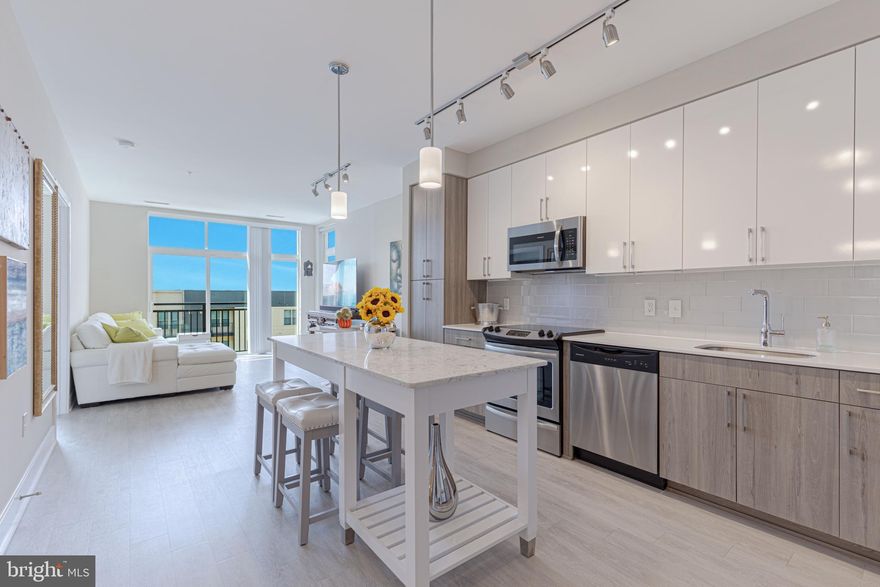 Enjoy resort style living in National Harbor at The Haven.  This condo conveys with an additional 140 cubic square foot in-building secured storage unit (originally purchased in 2019 for $7K with limited availability), and includes gated/reserved parking, and new (Jan 2023) full-size front loading Samsung smart app washer and dryer.

This top floor west-facing condo offers the ultimate living experience, complete with floor-to-ceiling windows, Juliet balcony, and unique corner window providing an end-unit feel with stunning horizon views for sunsets, MGM, and enjoying holiday fireworks displays from the comfort of your living room.  This light filled 1 Bed/1 Bath home features high ceilings with an open floor plan, with birch wood-style LVP flooring throughout.  A spacious kitchen with ample contemporary cabinetry, ethereal glass subway tile backsplash with stylish and durable quartz countertops, freestanding quartz island, sleek Grohe faucet, and stainless steel appliances.  The living area boasts enough space for living, dining, and entertaining.  A large bedroom with walk-in closet.  The adjoining bathroom, clad in modern tile with marble veining, includes a walk-in shower with glass enclosure, double quartz vanity with Moen fixtures, and large linen closet.    
 
When not enjoying your personal retreat, consider one of the many building lounges, complete with WiFi ideal for personal or business use, including work stations, party room with kitchenette, with TVs and a billiards table.  If fitness is your passion, hit the fully equipped gym, swim laps or relax in the heated pool and outdoor lounge areas.  The Haven includes a pet spa with grooming facilities, and climate controlled bike storage.  Friendly front desk Concierge is there to receive guests, secure and notify you of package deliveries, and to help you with anything you might need.  

Other notable highlights:  Key fob entries, electronic Kastle App with remote entry capability, Amazon package lockers, regular HVAC maintenance.  Easy commuting distance to the District, Northern Virginia and Maryland, as well as endless work from home options!  Discover what everyday resort living is all about!  The Haven is a recently constructed LEED certified residential building located two blocks from the waterfront, walking/biking trails, and numerous restaurants, hotels, and shopping. Schedule a showing today and immerse yourself in the luxury and comfort this residence and National Harbor has to offer.