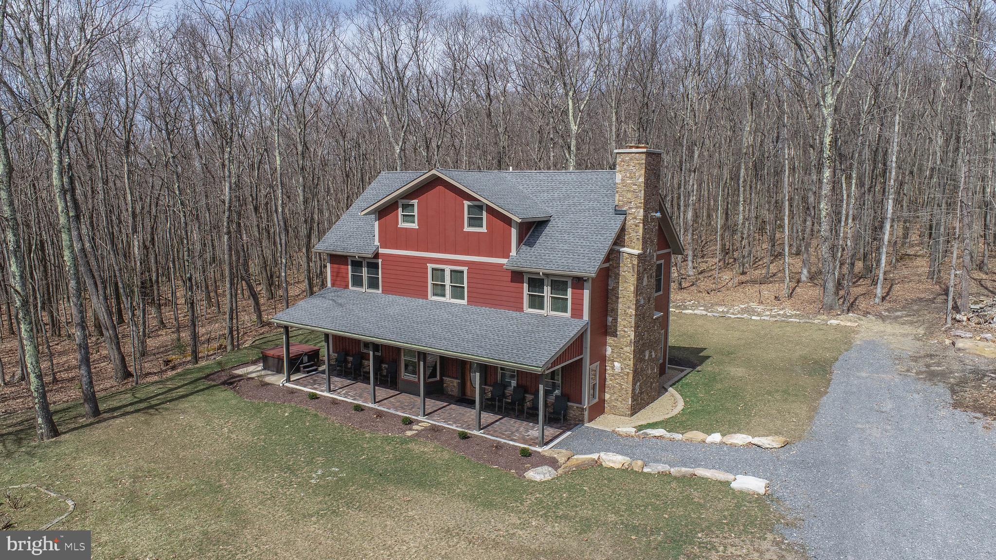 Very impressive and one of a kind Deep Creek Lake area home! This 5 bedroom house boasts 3 full above ground levels of living space and is located in a private setting yet incredibly close to all area amenities. This property would make for a perfect full time residence OR rental home. Established & existing rental on airbnb since November 2022. The home was essentially mid construction when purchased, and the current owner finished and redid everything inside and out. Tremendous attention to detail, high end finishes, and designed to maximize space throughout. Custom fireplace area, hot tub, impressive primary suite, and much more! You really have to see this one for yourself, it's absolutely gorgeous top to bottom.