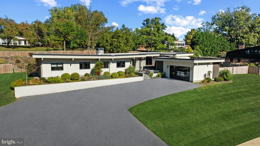 Welcome to 3410 Woodvalley Drive, an unrivaled mid-century modern residence where light, design, and craftsmanship come together. In 2018, the home underwent a full architectural renovation, reconstructed from the inside out with enduring comfort and no detail overlooked. Designed for long-term living rather than resale, every feature blends function and luxury. Passive-solar orientation allows winter sunlight to warm the interiors while roof overhangs limit summer heat. Inside features 10-ft ceilings, exposed beams, wide-plank flooring, and full-height interior and closet doors that stretch nearly floor to ceiling, enhancing the home’s vertical lines and airy feel. The chef’s kitchen includes Wolf, Sub-Zero & Bosch appliances, dual ovens, a five-burner gas range with custom hood, quartzite waterfall island, lift-up cabinetry, hidden outlets, and a drawer-style microwave. The primary suite offers two custom closet systems with built-in drawers and shelving, heated radiant floors, an oversized rain shower, ROHL fixtures, his-and-hers vanities, and custom blackout shades. Additional bedrooms have large windows, sliding barn doors, and built-in closet systems. The mudroom/laundry functions as a secondary prep space and butler’s pantry with deep sink, extra refrigerator, and custom cabinetry. Utility features include a full-home water filtration system and a tankless water heater. The 0.63-acre lot features full yard irrigation, original stone retaining wall with steps to the upper lawn, a six-foot custom wood fence (2023), a glass-door two-car garage, and an attached second storage garage. Architectural up-lighting showcases the home after dark. The backyard offers space for future amenities such as a pool or putting green, while preserving open green space. Modern California living, timeless elegance, and thoughtful design all come together here, a home this intentional and refined is rarely available in Woodvalley.