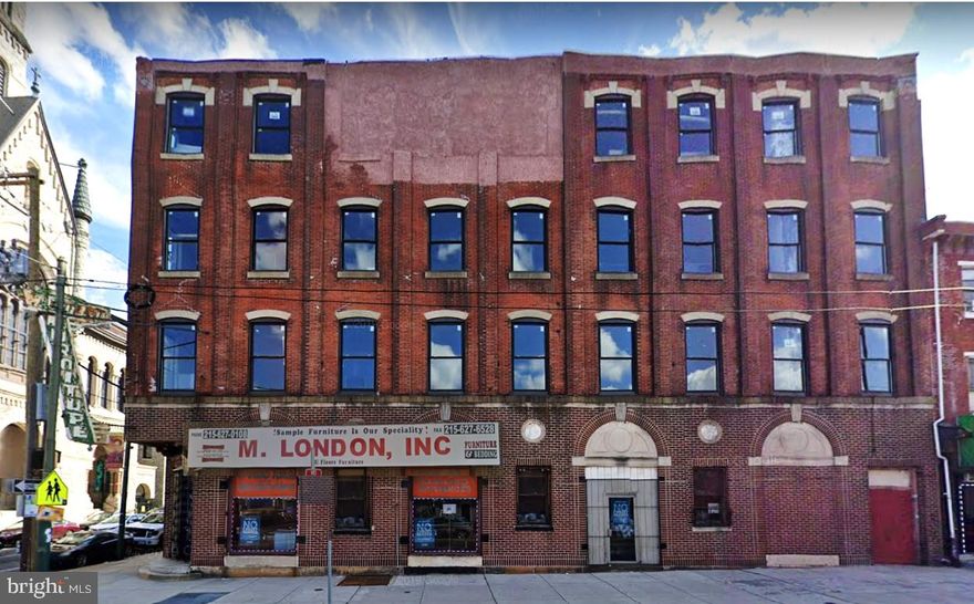 Situated on the southwest corner of North 5th Street and W. Girard Avenue, 1026-28 N 5th Street provides frontage of 80’ on W. Girard Avenue and 30’ on North Fifth Street. This prominent corner is Ideal for development as Restaurant / Commercial on the first floor and lower level, with Apartments or Creative Office space on the upper floors. 
The character of the building translates as “urban loft space” with high ceilings, wood beams, exposed brick, and original wood factory floors. Included in its four floors and lower-level space, is a freight elevator which serves floors 1-4. Two years ago, 34 new windows were installed, providing great light and views to the upper floors. There are 2 entrances to the property, both on Girard. The front is used for the store and there’s a rear entrance which could serve as a lobby for upstairs use, as the elevator and stairs are situated right there. The freight elevator has been in use as recently as 6 months ago but is currently out of order.