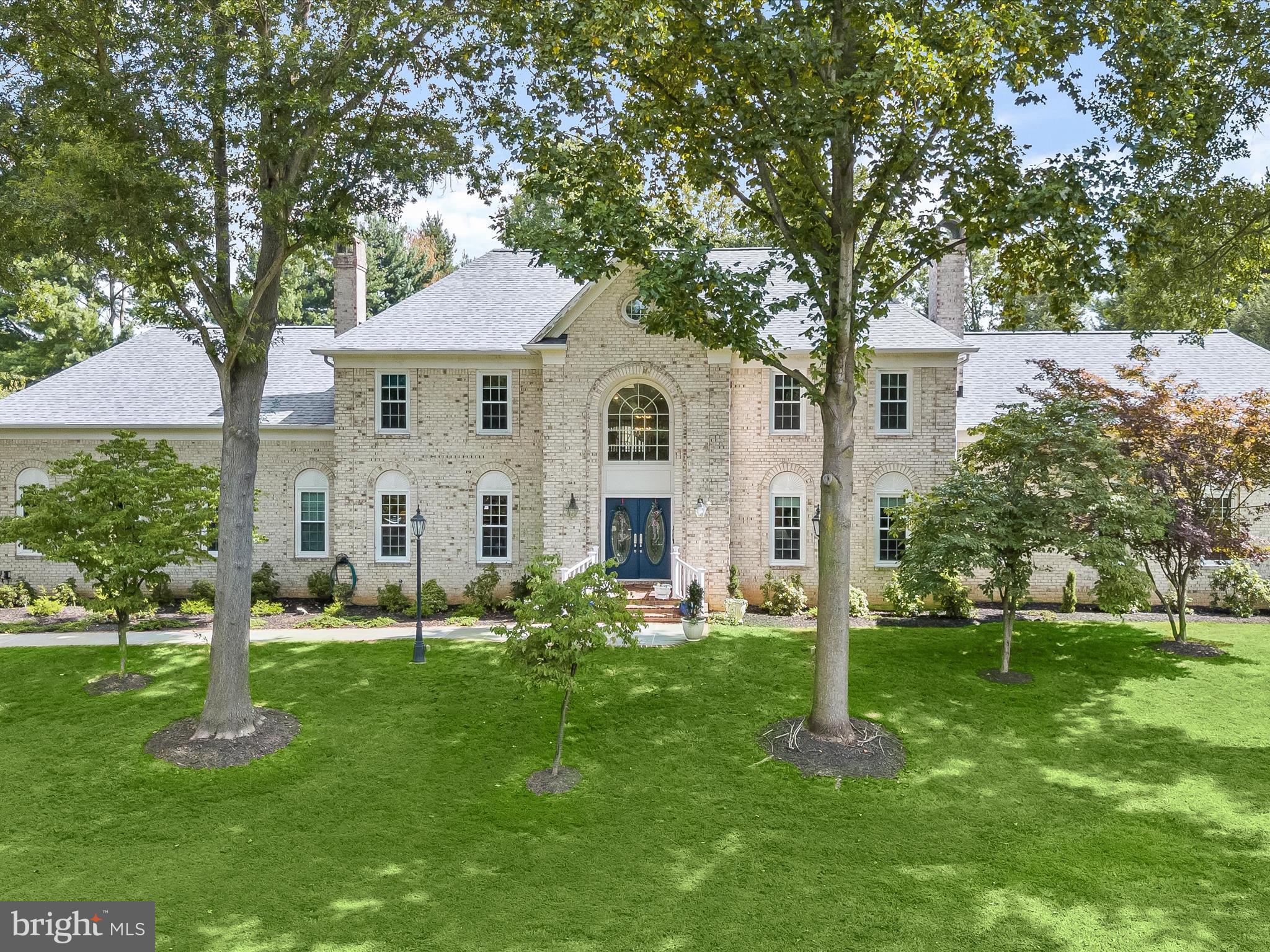 Goshen Valley, Gaithersburg, is a well-kept secret w/gorgeous homes 10 minutes from the best shops in Montgomery Co at Milestone/Neelsville Center, I- 270, & the MARC Train. The school system is a major draw with a variety of options, including nearby Montgomery College. The city was voted # 1 MOST DIVERSE CITY IN AMERICA, restaurants, parks & outdoor amenities abound. Goshen Valley Dr is a beautiful street with overarching oaks, children ride bikes on a cul-de-sac, & friendly neighbors chat taking walks. At 9117, a magnificent French colonial ivory brick mansion, with nearly $600,000 of new improvements, including new kitchen, new roof, skylights, windows, doors, & Lennox gas furnace. With two large wings, it sits impressively on the highest hill, from the 3-CAR GARAGE, to the two-story entrance with a glimmering marbleized porcelain tile floor. To the right, the living room has the 1ST OF 6 FIREPLACES & hand-blown sconces lighting wainscoted walls and brand new brilliant hardwood floor. To the left is the dining room & 2ND FIREPLACE, similar sconces & wainscoting. A curved stairway to upstairs sees the 3RD FIREPLACE & new family room with 3 skylights & bar cabinet. THE CHEF'S DREAM KITCHEN WITH ALL HIGHLY RATED GE MONOGRAM APPLIANCES HAS TWO 8 FOOT ISLANDS lit by 4 Tiffany-style chandeliers & all counters have rare AZUL BAHIA GRANITE. The prep island has a sink, conveniently next to the GE Monogram fridge/freezer, three 9-foot-tall pantries & roll-out drawers. The kitchen’s second island has a GE Monogram cooktop, retractable downdraft, warming drawer & solid wood KraftMaid soft-close drawers with dovetail corners for heavy pots & pans, & 2 two-tiered cutlery drawers. A pretty fan sits in a tray ceiling & hand-stenciling. A whisper-quiet dishwasher & wall microwave/baking oven over a convection oven, also GE Monograms, & 2 Fisher Paykel crystal washers. The main sink & breakfast nook boast a 27-foot-square portion of the newly extended deck. Beyond the pantries are 10-FOOT MIRRORED COAT CLOSET, shoe shelves, drawers, wall cabinets & a second fridge/freezer. Across is a mudroom with one of 3 WASHER/DRYERS, multiple drawers, & 2nd powder room (the first is off the entry hall). The conservatory seen through high windows from the family room features a 4TH FIREPLACE, four skylights, & three walls of tall arched windows. Dogwoods, magnolias, azaleas, Japanese maple trees, & forest beyond provide privacy. The first-floor primary bedroom suite with the 5TH FIREPLACE & brand new hardwood flooring, extends from the front to back of the house. Double doors open to the extensively mirrored primary bathroom, flanked by two 12-foot sink counters, newly refinished cabinets & large central jacuzzi. To the right & left are two 10-foot-long walk-in closets, shower room with a stacking 2ND WASHER/DRYER & a toilet room with a bidet. Prior to the master suite is a library with brand new hardwood flooring, built-in bookcases on three walls, on the fourth wall a 7-foot-tall picture window reaching the floor. Upstairs there are four large bedrooms with brand new carpeting, two full baths – one with a skylight & 3RD WASHER/DRYER. The bright, magnificent walkout lower level offers maximum versatility & functionality & is perfect for multi-generational/au pair possibilities, with a sixth bedroom, second kitchen, TV wall with reclining chairs, hardwood floors, wainscoted walls, & the 6TH FIREPLACE across from the bedroom that looks out a picture window to the backyard. There is a carpeted exercise room or playroom with a tropical mural, alongside the 4th full bathroom. Two pairs of French doors separate these rooms from a large party room, complete with full kitchen. Three sets of glass French doors lead out to a "slate patio" and the backyard. Two large storage rooms round out the lower level. House & deck have 2x12 beams/joists, with French drains around the foundation providing maximum water & moisture prevention. All it needs is YOU