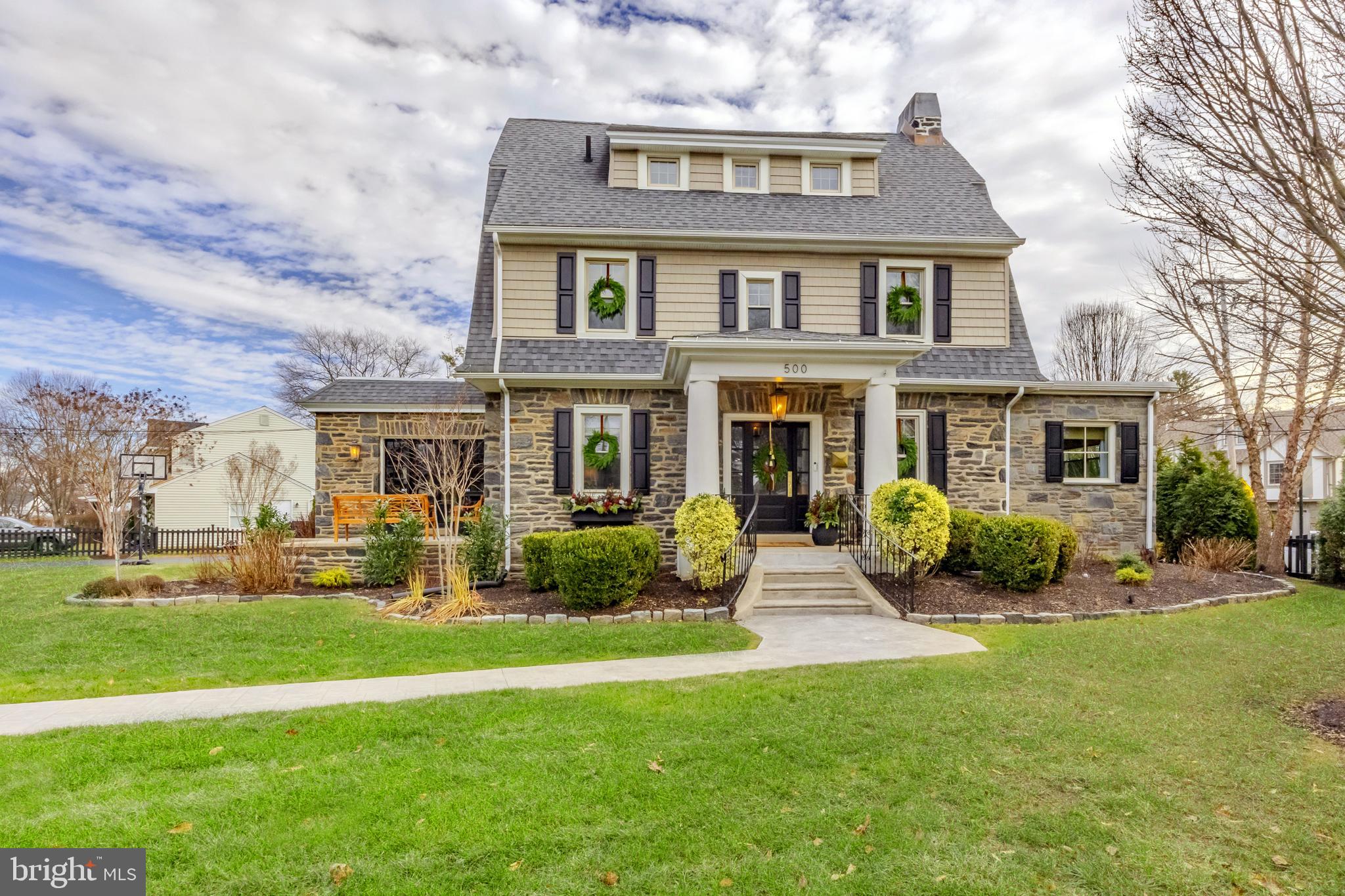 Nicknamed “The Brookline” because it’s the gateway to one of Haverford Township's most cherished, walkable, & historic neighborhoods. This very special 6 bedroom, 3 full, 2 half bath home has been loved & thoughtfully updated by its current owners from top to bottom. Each room offers a surprise, whether it’s custom built-ins, beautiful lighting, large windows & trim work details, or just a great view of the neighborhood. The floorplan is unbelievably versatile, with a phenomenal 3rd floor, a partially finished basement, & large room sizes. Pull up & fall in love with the professionally planned landscaping, the Wissahickon Schist stone, 100-year-old Belgian blocks bordering the front gardens (unearthed on the property), stately front entry & the oversized private driveway. Your guests will follow the walkway through the gate & enter at the covered front steps with original pillar detail & step into the foyer entry. The first floor has a phenomenal circular flow to include so much living space for every day life & for hosting the best parties ever! The living room was recently updated with custom built-ins designed to look original, offering storage, visual comfort lighting, & a bay window with custom window seat, the perfect spot for morning coffee & rainy afternoons. The formal dining room, with its original french doors & wainscoting is ready for your dinner parties. The exceptionally large kitchen has a great breakfast room nook, Carrara countertops, upgraded appliances, a large center island for storage/seating & two very large pantry closets. The mudroom has custom built-ins for daily life as well as a wall of cabinetry & a Carrara counter that is a perfect bar set up for hosting including a beverage refrigerator. The mudroom door leads you to the back bluestone patio & extremely private backyard which has been thoughtfully landscaped creating a sanctuary for you & your family. The first floor has a large office space with built-ins, & it’s right off a hallway called “the gallery” which is a fun space to decorate for holidays. The laundry room is amazing with a tile floor & tons of built-in shelving offering the perfect space for added storage. The family room also features a custom built-in with a new gas fireplace. The powder room has custom trim work & is perfectly tucked away. Upstairs on the 2nd floor you’ll find a very large primary suite with a large bedroom, 2 walk-in closets & a recently renovated bath with new Calcutta marble tilework, double vanity, large shower with niches & toilet closet. Also on the 2nd floor are two more bedrooms & a hallway bath. The 3rd floor offers 3 more bedrooms, a full bath & a large walk-in closet that is perfect for holiday & seasonal decor- it could also make a great office. The partially finished basement has a great industrial vibe, a half bath & 2 additional rooms for utilities & more storage space than you’ll know what to do with! The flow & space of this home can easily accommodate multi-generational living, an au pair, or the need for multiple offices & bedrooms. The property itself is a large corner lot & the home is perfectly situated. The entire property has been strategically landscaped & fenced and is extremely secure & special. The backyard is fully fenced, great for children & dogs & offers tons of privacy. There is so much green space on the Oxford Rd side, which is where the driveway is as well. Brookline is known for its beautiful old homes, each as unique as the next & the ability to walk to Havertown’s beloved attractions like the shops & eateries on the Blvd such as Centrella’s, The Bookery & McGillicuddys. Several schools & parks are nearby. Walk up to festivals along Darby rd & the Boulevard as well as a quick walk to public transportation. There is no other home quite like this one due to its size, stature & one of a kind appeal.