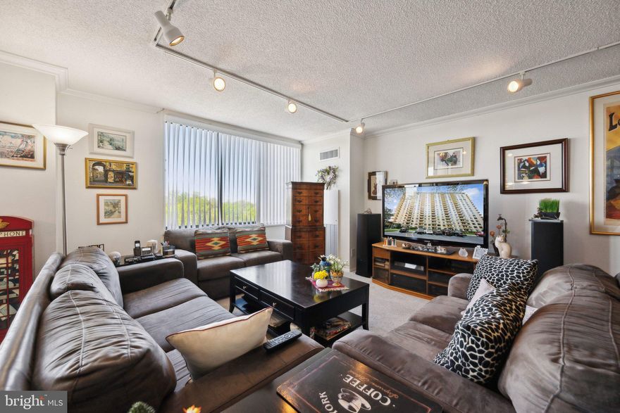 Welcome to 1418s an amazingly renovated 1 bedroom/den with lots of special extras like the automatic blinds in the bedroom.  This spacious unit has oversized windows throughout.  The kitchen has an arched entranceway, tile floor and granite counters.  The to-the-ceiling cherry cabinets have wonderful  designer pulls and provide a 60 bottle wine rack.  The appliances are all stainless.  There are under cabinet lights and the TV conveys.  There are 4 lazy susans in the cabinets.  In the foyer is a large walk-in closet and there are two other closets in the hallway.   The living room has track lighting.  There is crown molding, 6 paneled doors, and new wall-to-wall carpet throughout.   The bathroom is stunning with a walk-in shower, beautiful tile, 2 shower heads, and a large sink cabinet with plenty of storage.  The commode is a tall toilet. The mirror in the bedroom conveys if you want it.  The bedroom has two closets, one is a large walk-in.  The balcony, with its sunset views has recently been painted.  The building has so many activities and amenities, it lives like a resort.  The recently redecorated Arcade level has the state of the art fitness center with indoor pool and hot tub: locker rooms with showers and sauna.  Also in the Arcade is Chef Tony’s restaurant (a well known seafood/Italian eatery), a grocery store/deli, dry cleaners, travel agent, beauty salon, resident lounge, party and conference rooms.  There is a large outdoor pool with adjacent grills.  Tennis (lighted courts) and pickelball have their own building as you drive onto the property.  Ping pong is played regularly, as are social activities such as “Breakfast at Wimbleton”.  There are too many activities to mention them all.  A few are …trivia night, open mike night, monthly first fun movies, lectures, vaccinations, vote in all elections in the party room (including Presidential).  There is meditation, exercise class, book club, canasta, bridge, and mahjong.  We have wine and cheese get togethers in the lobby, a rocking New Year’s Eve party and various other celebrations.  We have car charging stations, and a car washing area with a dynamite vacuum.  Garage parking comes with the unit.  It is easy to get to the Red Line Medical Center metro stop at NIH/Walter Reed.  The bus comes to the door of the Promenade.  Close to 495 and 270.  Nearby Wildwood Shopping Center has Balduccis, CVS, Bethesda Bagels, Starbucks, a number of places to eat and several cute boutiques.  Giant food is just across the street.