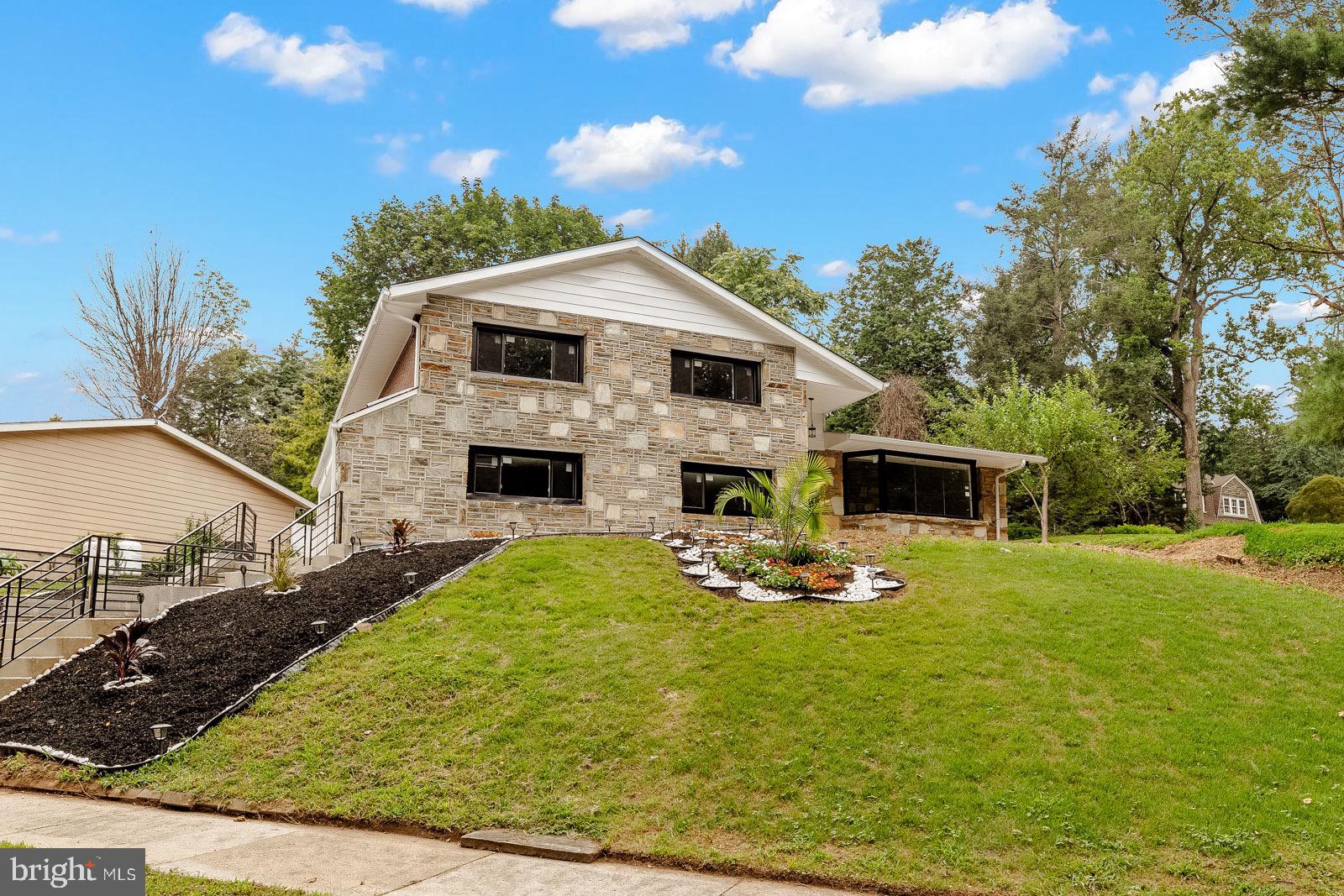 Welcome to this high-quality, beautifully renovated single-family home nestled in one of the most desirable areas of West Mount Airy. From the moment you step inside, you're greeted by sleek black tile flooring that flows effortlessly into a stunning, open-concept kitchen featuring custom black and warm oak cabinetry. The kitchen is a true centerpiece, boasting a dramatic waterfall island and a full quartz slab backsplash that exudes modern elegance. Throughout the home, all-new, high-end black-framed windows bring in abundant natural light while adding a bold architectural touch. With two spacious family rooms—one showcasing soaring high ceilings—this home offers both comfort and versatility. It includes four generously sized bedrooms and three luxurious full bathrooms, each thoughtfully designed and tiled from floor to ceiling with premium finishes. A fully finished basement provides additional living space for a home office, gym, or entertainment area. Completing this exceptional property is a two-car garage, making this home the perfect blend of style, quality, and convenience in the heart of West Mount Airy.