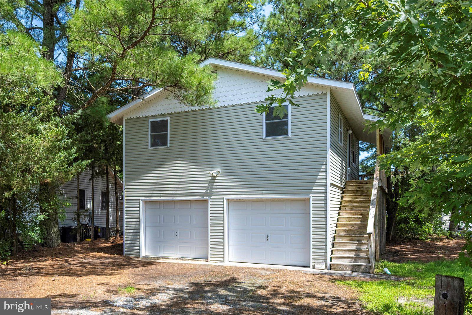 Welcome to 12 White Sail Cir, a two-bedroom home full of expansion potential. Featuring an elevated floor plan on pilings, this home boasts LVP flooring throughout, an open floor plan with abundant natural light, easy one-level living with two full bedrooms and a full bath, and a fresh coat of paint throughout, making it ready to move right in. Soak up the outdoors with a screened porch, a wrap-around deck, and finish the ground level with a covered deck or patio. On the ground level is an oversized garage with high ceilings, perfect for boat storage and other motorized toys, an outdoor work space, or finish the space and add on to the existing home. If you're looking for the opportunity to grow with your home, then you'll love the possibilities. Finish the garage to add bedrooms and baths, enclose the screened porch to add to the upstairs, the options are endless! Located on popular White Sail Cir, you'll enjoy cul-de-sac type living with a quiet waterfront street close to the community center and farmer's market. The Ocean Pines community has something for everyone with indoor and outdoor pools, an oceanfront beach club in Ocean City with pool, baths, and restaurant, a golf course, marinas, numerous parks and playgrounds, sports courts, farmers markets, and so much more! All of this just a short drive from the sandy beaches of Ocean City. Offered with a 1-year home warranty, this home is ready to be yours. Schedule your private tour today.