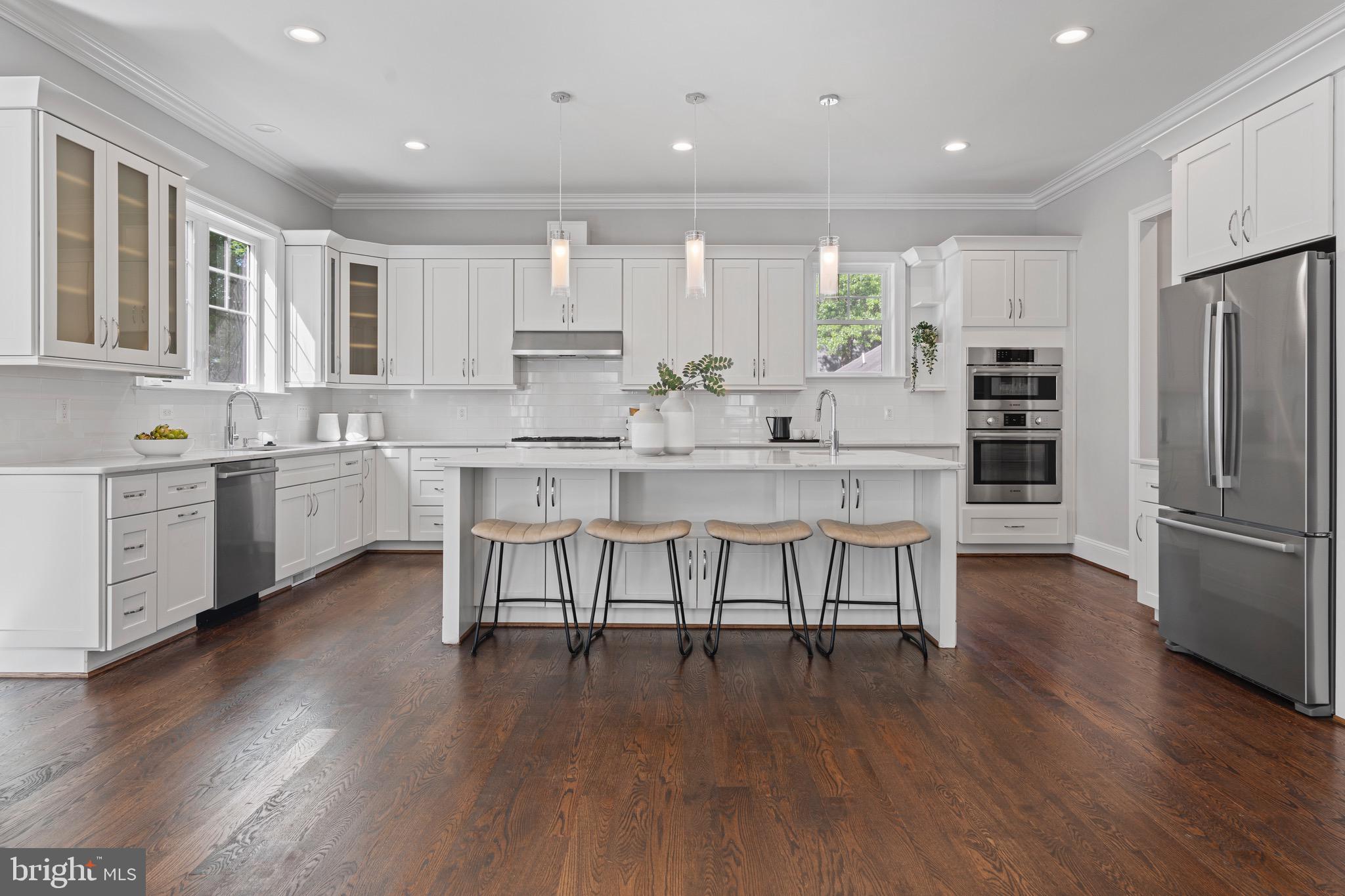 Welcome to 7606 Leonard Drive, an exceptional five-bedroom, five-bathroom residence gracefully situated in the highly desirable Pimmit Hills community. Built in 2019 and offering over 6,300 square feet of meticulously designed living space, this home seamlessly blends refined elegance with everyday comfort in one of Northern Virginia’s most connected locations.
From the moment you enter, you’re greeted by soaring ceilings, rich hardwood flooring, and custom millwork that elevate the home's modern Craftsman aesthetic. The gourmet kitchen is the centerpiece — a striking blend of form and function — featuring professional-grade stainless steel appliances, a six-burner range, an oversized island with bar seating, and expansive quartz countertops that invite culinary creativity and effortless entertaining.
The main living spaces are bright and airy, flowing effortlessly from the formal dining area to the expansive family room adorned with custom built-ins and a cozy fireplace. A thoughtfully designed floor plan allows for both grand-scale entertaining and intimate gatherings, while large windows frame views of the landscaped backyard.
Upstairs, the serene primary suite is a retreat of its own, offering a spa-like en-suite bath with a soaking tub, dual vanities, and a walk-in shower. Additional bedrooms are generously sized with ample closet space and private or adjoining baths, ensuring comfort for family and guests. The fully finished lower level expands the lifestyle possibilities, with space for a home theater, gym, or recreation room tailored to your needs.
Outside, a lush and private yard provides the perfect setting for alfresco dining, weekend barbecues, or simply enjoying a quiet evening under the stars. Set on a 10,000+ square foot lot, the home offers both space and seclusion just minutes from Tysons Corner, downtown McLean, and major commuter routes.
This is luxury living reimagined—where timeless design meets modern convenience, in a location that places the best of Northern Virginia at your doorstep.