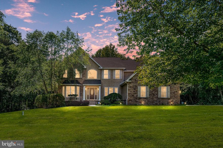 <p>Welcome to Woodholme in The Village of Elk Neck! Situated on a beautifully landscaped lot surrounded by mature trees and natural scenery, this impressive stone-front colonial combines timeless curb appeal with expansive living space and exceptional entertaining amenities. A stamped walkway leads to the covered front entrance and into a dramatic two-story foyer featuring hardwood flooring, abundant natural light, and an elegant open staircase overlooking the main level.</p> <p>The main level offers a desirable blend of formal and casual living spaces designed for both everyday living and entertaining. Formal living and dining rooms provide inviting gathering areas, while a sought-after main-floor office offers flexibility for working from home, study, or additional living needs.</p> <p>At the heart of the home, the impressive two-story family room features expansive windows and a striking floor-to-ceiling stone fireplace. Natural light fills the space while maintaining strong visual connection between the family room, kitchen, and breakfast area.</p> <p>The gourmet kitchen is thoughtfully designed and features granite countertops, abundant cabinetry, stainless steel appliances, built-in appliances, center island with seating, extensive prep space, and adjoining breakfast area overlooking the rear yard.</p> <p>Upstairs, the owner's suite serves as a spacious and private retreat complete with sitting area, generous walk-in closet, and bath featuring dual vanities, soaking tub, and separate shower. Additional bedrooms offer comfortable accommodations and flexibility for family, guests, or changing household needs.</p> <p>The finished walk-out lower level substantially expands the home's living and entertaining space and represents one of its most impressive features. A dedicated theater room with tiered seating and projector setup creates a true cinematic experience for movie nights and sports viewing.</p> <p>Beyond the theater room, the lower level includes expansive recreation and gathering areas enhanced by a second stone fireplace and open layout ideal for gaming, entertaining, or extended living flexibility.</p> <p>A major highlight is the custom wet bar and entertainment area featuring granite countertops, rich cherry cabinetry, built-in sink, microwave drawer, dishwasher, beverage storage, decorative columns, and extensive serving and prep space. Open to the surrounding recreation areas, the wet bar creates an ideal setting for hosting guests, celebrations, and game days.</p> <p>Outdoor living is equally appealing with an elevated rear deck overlooking the backyard and mature wooded surroundings, along with a rear patio accessed directly from the walk-out lower level. These multiple outdoor living areas complement the scenic setting and natural privacy while creating ideal spaces for outdoor dining, entertaining, or relaxing outdoors.</p> <p>Architectural details throughout the home contribute to its warm and inviting character, while soaring ceiling height and open sightlines enhance the overall sense of space.</p> <p>The lower level's thoughtful design allows multiple entertainment zones to function together while still providing comfortable separation for movies, gaming, recreation, and gatherings.</p> <p>The elevated rear deck and walk-out patio create seamless indoor-outdoor flow and offer multiple spaces to enjoy the surrounding wooded setting and changing seasonal views.</p> <p>Additional highlights include an oversized garage with custom storage, owned propane tank, hardwired security system, and exterior sprinkler system.</p> <p>Conveniently located near shopping, dining, marinas, and local amenities, this exceptional home combines dramatic architectural features, expansive living spaces, and outstanding entertaining amenities within the desirable Woodholme community. HOA is approximately $500 annually and managed by Aspen Property Management.</p>