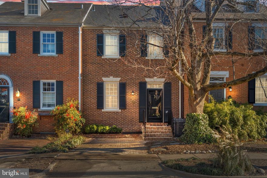 Improved Price! SOUTHEAST QUADRANT location with off-street parking  in an amazing block of  historic homes. Large light-filled room sizes like you're not used to in Old Town!   One minute to the waterfront and a STUNNING VIEWS OF THE POTOMAC and National Harbor from the Primary Bedroom Suite/ in-home office.  This handsomely maintained brick townhome is in a superior locale near Lee Street Park & the Potomac River. There are four finished levels- 2,450  square feet- an outstanding value in the heart of Old Town.  A true foyer is welcoming while the gracious living room with fireplace is adjacent to the dining area and galley kitchen. The lower level Family Room with fireplace is adjacent to the private brick Georgetown patio and bedroom and full bath- the perfect au pair or guest quarters. On the second level is the first Primary Bedroom with gleaming hardwood floors and an ensuite bath and two closets.  Another bedroom  and full bath on this level are featured.  On the second upper level is another enormous Primary Suite/ Office overlooking the Potomac River with two walk-in closets and an ensuite bathroom.  There is a brand new roof, fresh paint throughout, gleaming hardwood floors and two zone heating & cooling. Numerous built-ins & generous closets. Coveted off-street parking! No HOA!