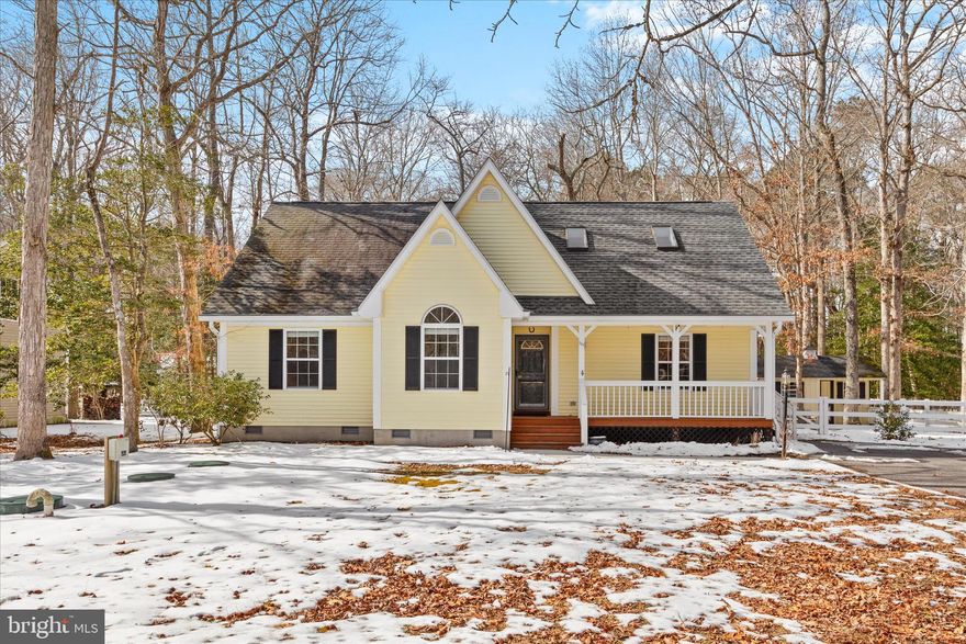 Nestled on a spacious lot in the welcoming Bethany Forest community, this charming and beautifully updated home offers comfort, character, and peaceful natural surroundings. A quaint front porch and extended driveway create an inviting first impression, while a convenient side entry provides easy everyday access.

Step inside to discover a bright open floor plan where the living, kitchen, and dining areas flow seamlessly together, all enhanced by rich hardwood flooring and fresh paint throughout the home, including cabinetry and interior doors. The living room immediately captures your attention with its soaring two story ceiling, new ceiling fan, and cozy wood burning fireplace, creating a warm and relaxing gathering space. The kitchen has been thoughtfully upgraded with stylish lighting, quartz countertops, and stainless steel appliances, including a Bosch Silence Plus dishwasher. A designated dining area, accented by upgraded lighting, offers the perfect setting for both casual meals and entertaining.

Down the hall, you will find a full bath, laundry area, and a secondary bedroom highlighted by a vaulted ceiling and a beautiful Palladian window that fills the room with natural light. Another bedroom offers flexibility for guests, family, or a home office. The primary suite provides a peaceful retreat, featuring an upgraded en suite bath with a soaking tub, quartz topped dual vanity, modern lighting, and a tiled glass enclosed shower. A window above the tub allows fresh breezes to drift in while you relax and unwind.

Just off the living room, a sunroom extends the living space and provides tranquil views of the backyard oasis. The low maintenance evergreen AstroTurf lawn backs to a wooded setting, offering exceptional privacy and a serene outdoor environment. Imagine evenings spent relaxing beside the fire pit, swaying in a hammock, or enjoying nature and wildlife in your own backyard. An outdoor shower offers the perfect place to rinse off after a day at the beach. A storage shed is already in place, and the spacious yard may have the potential to add a detached garage if desired. Upstairs, new carpeting leads to a bright loft area featuring skylights that flood the space with natural light. An additional bedroom with a private attached bath makes this level ideal for guests or extended family.

This home has been meticulously maintained with numerous recent improvements, including upgraded bathroom lighting fixtures, replaced fan covers, updated lighting throughout, storm doors on all exterior doors, professional power washing, a septic repair and Class H inspection completed in February 2025, repaved front sidewalk, installed rain gutters, a new HVAC system installed in spring 2024, and a new roof installed in 2021.

The fenced wooded backyard offers a quiet, private setting. Located within a well established neighborhood with minimal traffic, and low HOA fees. Residents of Bethany Forest enjoy amenities including a community swimming pool and tennis/pickleball  courts. Outdoor enthusiasts will appreciate the nearby Holts Landing State Park and surrounding rural landscape filled with native wildlife, including hawks, owls, woodpeckers, bluebirds, and hummingbirds.

Conveniently located approximately six miles from the Bethany Beach boardwalk, this home provides easy access to beaches, dining, shopping, and coastal attractions, offering the perfect blend of relaxation and coastal living.