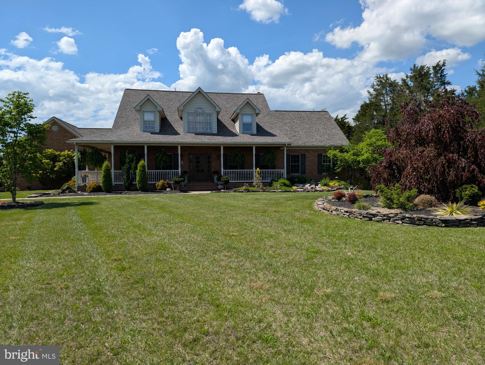Welcome to 15920 River Bend Court. Custom built by the current owner, this magnificent five-bedroom, six-bath executive home is situated on over nine acres with meticulously maintained lawns, natural wooded areas, and a tranquil stream offering the perfect balance of privacy, space, and convenience. It is perfect for outdoor enthusiasts, located within minutes to the C&O Canal, boating on the Potomac River, 20 minutes to Whitetail Ski Resort and just minutes from I-70 and I-81. As you drive down the long, winding driveway, you are greeted by the impressive sight of this elegant brick residence. Extensive oriental landscaping outlined by dry stack stone and custom wood fence with gabion posts define the home. There is plenty of sitting space on the Southern inspired wrap-around front porch to sip your morning coffee and listen to the custom waterfall or on the expansive back deck to entertain and watch the amazing sunsets and abundant wildlife. Upon entering the main foyer, you will find the first-floor master suite to your right. This suite includes a walk-in closet, cathedral ceiling, electric fireplace, and en-suite bathroom. The master bathroom has a jetted Jacuzzi tub, ceramic floors, dual sinks, and a shower. The adjacent bedroom will make a perfect nursery or could be converted into your dream walk-in closet with sitting area. There is also a half-bathroom across the hall. Heading back to the main foyer, you enter an open living area that comprises a den, gourmet kitchen, dining room, and a living room featuring a wood box and wood-burning fireplace. The kitchen is equipped with soapstone countertops, plenty of custom cabinetry, a propane cooktop, ceramic tile flooring, and stainless-steel appliances including double ovens and a large island. The kitchen patio door opens to the spacious back deck. The adjoining expansive dining room is designed to accommodate the entire family for both formal and intimate gatherings. Moving through the kitchen you’ll enter the adjacent hall with front and rear side entrances, oversized two car garage, and laundry area with sink and plenty of cabinets. The attached garage has custom made knotty alder wood garage doors, wall-mounted tv, two ceiling fans and wifi garage door openers equipped with video for extra added security. Recessed lighting and hardwood floors accentuate the main level. Moving up to the second level, the second-floor landing overlooks the main entrance of the home and the main living area. Upstairs are the third and fourth bedrooms both with large walk-in closets, and dormers with window seats. The main full bath and the fifth bedroom with its own full bath complete this level. Heading down to the lower level, the basement features a spacious family room, rec room, game room – whatever your heart desires. It includes a large built-in bar ideal for entertaining, along with a half bath, storage area, and utility room. (Basement is in the process of being finished, just waiting on the flooring to arrive.)
Recent updates include a new roof in 2024, new HVAC system, water softener, and garage doors. Sure to impress, this exclusive property is meticulously maintained and enjoyed. Don’t miss seeing this amazing property! Be sure to call Listing Agent to schedule your exclusive private tour today. Professional photos and video tour coming soon!