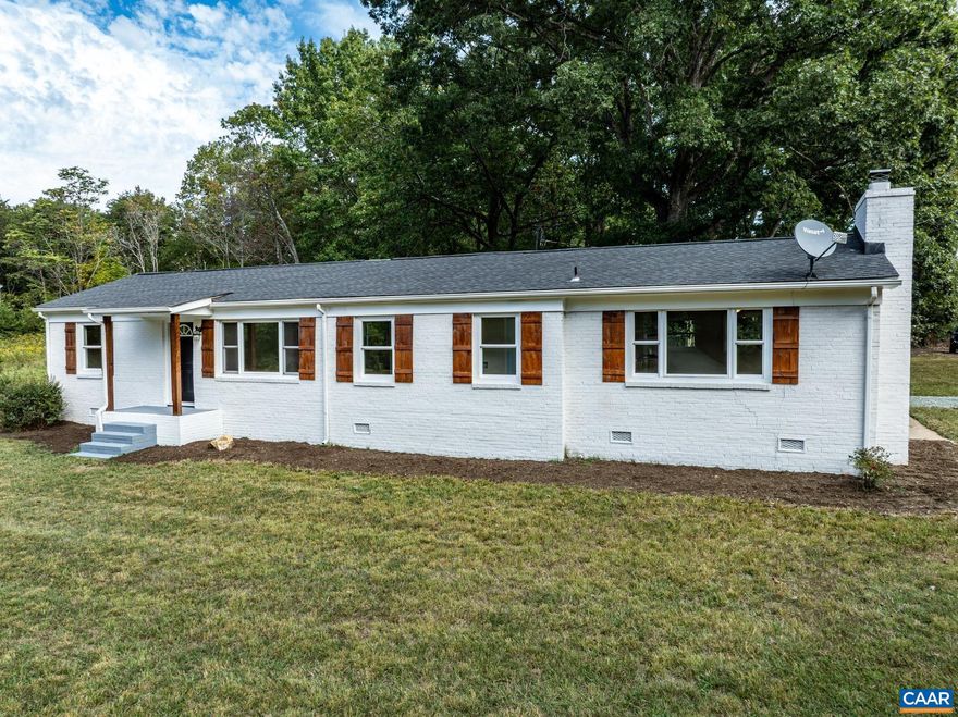 Experience one-level living in this fully remodeled brick ranch, perfectly situated on 1.5 acres in Louisa. This is a truly move-in-ready opportunity! The light-filled, open concept home has a connected living room, dining area, and the full updated kitchen with new granite countertops, white cabinetry, modern tile backsplash, and stainless steel appliances. Retreat to the primary suite, featuring a cozy fireplace, a walk-in closet, and an updated private bath. Two additional bedrooms have new carpet and share a remodeled full bath. Practicality meets curb appeal with a two-car carport that doubles as a covered porch area. The expansive 1.5-acre lot is flat and landscaped, offering a perfect setting for outdoor enjoyment. Don't miss this blend of country tranquility and convenient access to Charlottesville!,Granite Counter,White Cabinets,Fireplace in Master Bedroom