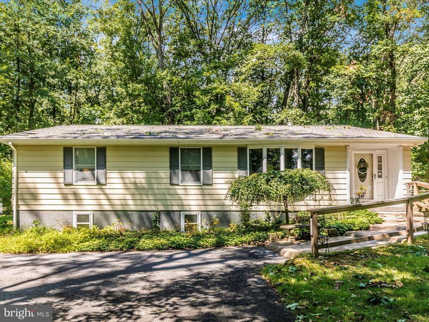 Tucked away on a quiet street in Carroll County you will find this cozy rancher on a private 1 1/2 acre lot. Updated and beautifully maintained, light pours into the front room from the large bay window. The kitchen is well appointed with a wall oven, built in microwave oven, granite countertops, gorgeous tile flooring and a cooktop eat-in island. The kitchen opens into a large room offering endless possibilities. Off the kitchen, take in the serene surroundings on the screened-in porch and decking. The primary bedroom provides a full bath with dual sinks and stand-up shower. An exterior door also delivers direct access to the back decking. In a large hall closet you will find the washer and dryer conveniently located. Boasting a jacuzzi tub, the hall bath sits adjacent to the front 2 bedrooms. Having exterior access, the basement is partially finished and ready to be what you want it to! An expansive driveway runs into the detached 2+ car oversized garage. The roof was replaced in 2020.