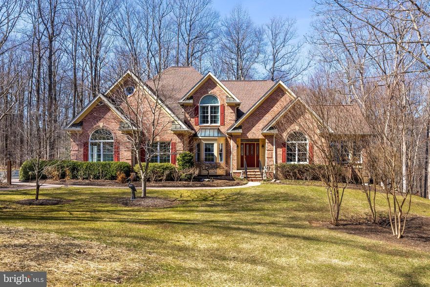 Nestled in one of Monkton’s most desirable neighborhoods, this stunning all-brick home offers approximately 5,200 square feet of luxurious living space above grade and an additional 2,150 square feet in the lower level. Designed to evoke the charm of an English Country Home, it is set on a truly exceptional lot with breathtaking views of the 137-acre Wesley Chapel Woods community and one of the nicest lots you will find in Monkton and Wesley Chapel Woods. The expansive grounds are a serene blend of lush gardens, mature trees, and open green spaces, creating a park-like setting that is perfect for enjoying the wildlife and peaceful scenery throughout the year. Inside, this sun-filled residence boasts detailed moldings, soaring ceilings, and large palladium-style windows that seamlessly connect the interior with the surrounding beauty. The open floor plan flows effortlessly from room to room, ideal for both everyday living and entertaining. Highlights of the main level include a bright sun-lit living room with vaulted ceilings and custom box molding, a 19' x 15' sunroom with panoramic views, and a spacious family room with a raised hearth brick fireplace. A large kitchen with a breakfast room leads to a screened porch and deck, while a 21' x 14' office with a separate entrance offers versatile potential as an in-law suite or guest quarters. Upstairs, the generously sized primary suite offers a private retreat, with a luxurious en-suite bathroom and hallway to the other bedrooms, two additional full bathrooms, and a 2nd staircase leading to the Kitchen/Breakfast Room. The lower level expands the living space even further, featuring a second family room, an expansive game room, a large wet bar, and a fourth full bathroom—perfect for entertaining. With ample storage and a walkout design, this lower level provides both practicality and space for all your needs. Outdoor living is equally impressive, with the large deck, bluestone patio, and beautifully landscaped gardens, making this home a perfect oasis for hosting gatherings or enjoying a quiet evening. The home is equipped with a propane generator and separate guest parking, adding both convenience and peace of mind. This exceptional property offers the ultimate in luxury, comfort, and privacy, set within one of the best locations in the highly sought-after Wesley Chapel Woods community.