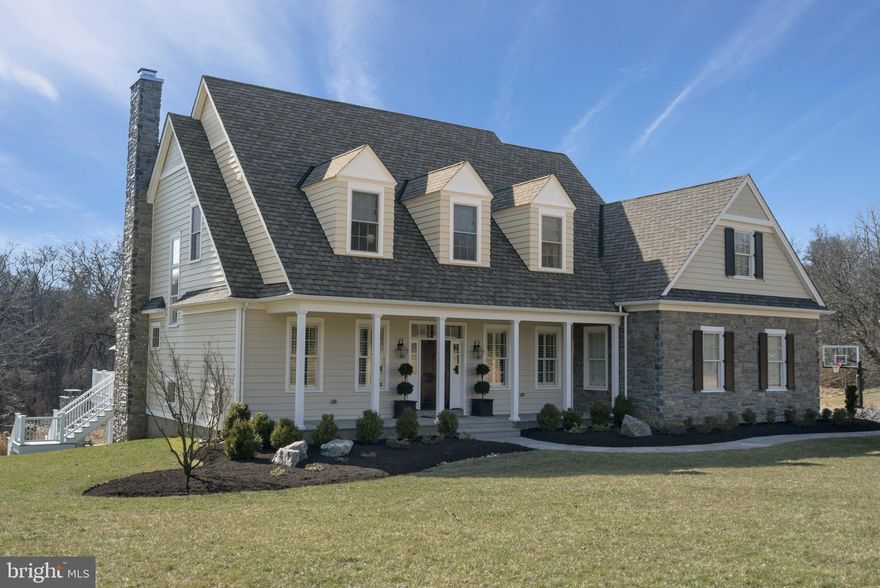 Stunning 6 year young home, situated on 2.4 acres of natural land boasting privacy & beautiful scenic views.  This right size home built by the current owners is beautifully appointed. The winding flagstone walkway leads to the welcoming front porch. Step inside, you will immediately be wowed by the interior features; extensive custom millwork, hardwood floors, paneled wainscoting, 10 ft ceilings, exquisite lighting fixtures, impeccably decorated & open floor plan. Over 5300 Sqft of living area on all 3 levels. Enter the foyer with office on one side, & formal dining room on the other. The impressive formal dining room, features beaded-inset paneled walls & an elegant gold candlestick chandelier that anchors the room perfectly.  The center hall leads straight to the bright, open family room featuring views of the open natural land surrounding the house. This room is anchored by the impressive wood fireplace with built-in shelves & coffered ceiling. Leading from the family room is the elegant & bright kitchen. Custom kitchen features beaded-inset Mouser Cabinetry, subway tile, mounted pot-filler, oversized island with marble countertop, large farm style sink, & modern pendant lighting, & separate desk area.  Upgraded appliances, Thermador Professional Series, include range with propane fed 6 burner cooktop & dual electric ovens, 48  refrigerator/freezer, & dishwasher.  Sunny & bright, the breakfast room features a wall of windows, beadboard ceiling, elegant wrought-iron chandelier & access to deck.  Off the kitchen is a large pantry & mud room. Impressive herringbone patterned floor, this room features pantry, built-in cubbies, bench & hooks & access to the 3-car attached garage.  The butler s pantry with handsome beaded-inset cabinets with walnut top & gold pulls, speckled backsplash mirror, & wine refrigerator complete this area. Modern powder room features tasteful wallpaper, accenting the gold touches found throughout the house. The turned staircase opens to the center hall & family room featuring a large oversized window with cozy window seat & a massive modern chandelier. Hardwood floors continue to the 2nd flr. The spacious master suite offers large bedroom and master bathroom with his & her vanities with marble tops, large mirrors, soaking tub with marble & enclosed oversized marble shower . he walk-in closet features a built-in dresser, chandelier & a plethora of hanging bars & shelves.  Bedroom 2 features access to a hallway bathroom with Corian top vanity, beehive hexagon black & white tile, & subway tiled stall shower. Bedrooms 3 & 4 are served by a Jack & Jill bathroom featuring grey tile floor, tub/shower combination. Laundry room offers cabinetry, granite top, sink, front loading washer & dryer. The open staircase leads to an amazing finished lower level. This level features a seating area with daylight windows, built-in cabinetry & shelves, 10  ceilings, 5th bedroom/office with murphy bed, large closet & full bathroom. The bar area has seating for 4/5, walnut countertop, custom cabinetry, refrigerator, sink, icemaker & Bosch dishwasher. Walk out from the lower level to the stunning outdoor patio. The covered area includes built in grill, cooler, ceiling fan, & seating area. Speaker system serves the basement, kitchen, family room, deck and patio.  The custom-built stone wood fireplace surrounded by seating area provides many months of entertaining.  Stairs connect the flagstone patio to the deck off the kitchen. Little Valley Creek runs through the back of the property, as it also touches on the pond. Incorporating the history and character are stone walls off the patio,  the rustic ruins of a large stone barn from years gone by. The exterior of the home is gray mica schist stone & hardie board siding.  Award winning T/E School District. This private lot & newer home affords affords the opportunity to have it all within close proximity to shopping, restaurants, major highways, and the train!