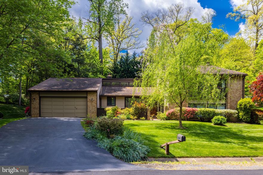 Welcome to 7321 Hooking Road, a meticulously maintained contemporary home nestled in one of McLean's most desirable areas. This 5-bedroom, 3-bathroom property offers over 4,250 square feet of light-filled living space on a beautifully landscaped half-acre lot.

The mirrored foyer leads to a spacious living room with a floor-to-ceiling brick fireplace and a wall of windows that bathe the room in natural light, offering great views of the private backyard. The formal dining room is perfect for hosting dinner parties and special family gatherings. Both the living room and dining room feature vaulted ceilings.

The gourmet kitchen is a chef’s dream, boasting natural wood cabinets, granite countertops, and a center island with a breakfast bar. The breakfast nook has lovely views and sliding glass doors leading to the front courtyard. There's also a sunroom with a wall of windows and sliding glass doors to the backyard. The large family room includes a raised hearth brick fireplace, a wet bar, and sliding glass doors to the back patio. Additionally, the main level features two bedrooms, a full bath, and a laundry room.

Hardwood floors extend throughout the upper level. The master suite is a true retreat with a dressing room that could serve as an office nook and an en suite bathroom. There are two additional bedrooms and a full hall bath.

The finished basement provides extra living space with a large recreation room, two storage closets, and a wine room with a bar. The beautiful and private backyard is an entertainer's paradise with mature trees and plenty of space.