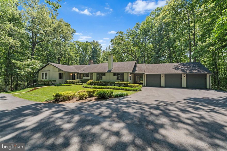 Tucked away on five private wooded acres in sought-after Clifton, this custom ranch-style home offers the perfect balance of privacy, space, and convenience just minutes from major commuter routes and less than 30 miles from Washington, DC.

Designed for comfortable everyday living and effortless entertaining, the home features a predominantly main-level floor plan with a spacious primary suite, light-filled living areas, rich hardwood flooring, and a dramatic wall of windows overlooking the indoor pool and expansive outdoor living spaces. The family room is anchored by a striking raised-hearth fireplace, while the kitchen blends timeless design and functionality with a large center island, JennAir appliances, double ovens, a Sub-Zero refrigerator, Corian and ceramic countertops, and a built-in planning desk.

The fully finished walkout lower level expands the home’s versatility with an additional bedroom, full bath, recreation and game area, wet bar, and direct access to the outdoors.

Outside, mature trees create a peaceful retreat setting, while the detached three-car garage provides abundant storage and workspace. A whole-house Generac propane generator offers valuable peace of mind and uninterrupted comfort year-round, an exceptional feature for a property of this size and setting.

Additional infrastructure includes a private well, conventional four-bedroom septic system, Trane HVAC system (2018), and electric water heater (2018).

Located near the historic Town of Clifton, this unique property combines the tranquility of country living with convenient access to dining, shopping, parks, trails, and the greater Washington metropolitan area.