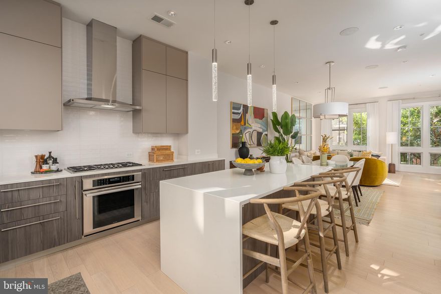 Welcome to 306 S Union Street, an exceptional townhouse in the award-winning Robinson Landing community blending modern luxury with timeless design. Bathed in natural light from oversized windows, the home offers bright, open spaces and clean, contemporary finishes that make everyday living feel effortless.  2,452 finished square feet spread across four levels, the flexible layout includes 3 spacious bedrooms, a private home office, a top-floor family room, and a main-level open-concept kitchen, dining, and living area that opens to a private deck—perfect for seamless indoor-outdoor living. Host sunset gatherings on the rooftop terrace, complete with an outdoor kitchen.  Enjoy top-of-the-line finishes throughout including Snaidero cabinetry, Thermador appliances and quartz counters in the kitchen, a gas fireplace offering a cozy ambiance, 2-car garage and much more. Robinson Landing offers exceptional amenities including 24/7 concierge service, on-site staff, a state-of-the-art fitness center with river views, yoga studio, pet grooming spa, elegant lobby, resident lounge, library, and club room. Enjoy a morning coffee at the waterfront café or take in the scenery with a stroll along the promenade. Dine at popular local spots like Barca and Ada's on the pier, just steps from your door. Located just three blocks from King Street’s vibrant shops and restaurants, and minutes to Reagan National Airport, Amazon HQ2, Capitol Hill, and downtown D.C., this home delivers the best of Old Town living with unmatched convenience and style.