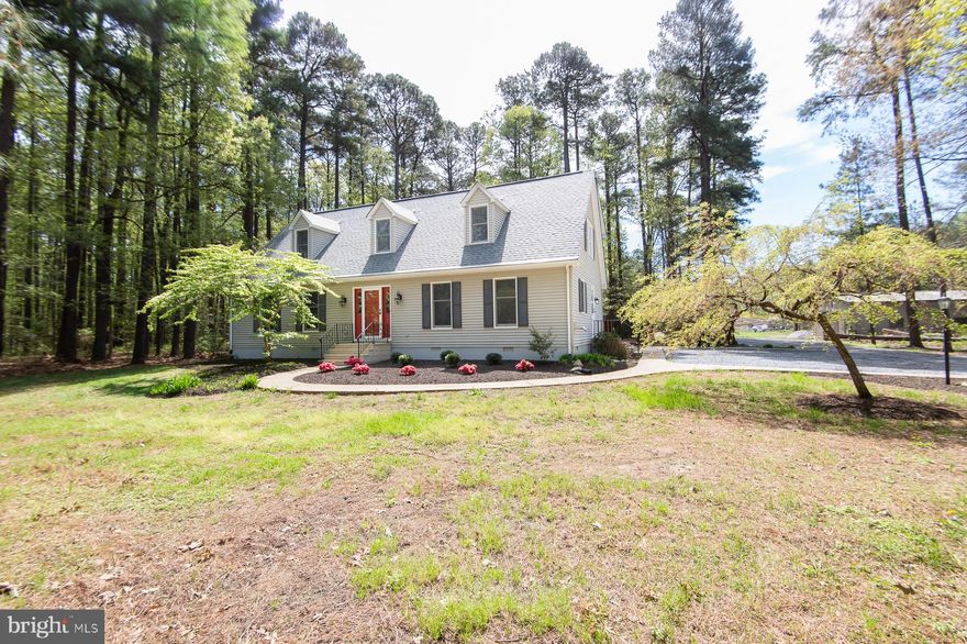 Completely renovated from top to bottom, this exceptional home sits on nearly 7 private acres in the highly sought-after Neck District of Dorchester County, offering the perfect blend of modern comfort and peaceful country living. A brand-new architectural shingle roof and thoughtfully redesigned open floor plan create a stunning great room where the kitchen, living, and dining areas flow seamlessly together—ideal for both everyday living and entertaining.

The beautifully updated kitchen features new countertops, a ceramic tile backsplash, and all-new appliances. Additional improvements include updated bathrooms, all new flooring, wiring, lighting fixtures, and fresh landscaping throughout—no detail has been overlooked.

The first floor offers two bedrooms and one full bath. Upstairs, the spacious primary suite includes a private bath and walk-in closet, along with two additional bedrooms and another full bathroom.

Step outside to a generous rear deck overlooking the pond and large outbuilding—an inviting space to grill, entertain guests, or simply unwind under the stars while taking in the serene surroundings. The expansive property is surrounded by mature woods teeming with deer, turkey, and other wildlife, creating a true retreat where privacy and nature take center stage.

A large metal outbuilding (45'x30') with a concrete floor provides endless possibilities for a home-based business, workshop, hobby space, or storage for boats and recreational equipment. Enjoy the quiet lifestyle of country living without sacrificing convenience—located less than 10 minutes from Cambridge.

A rare opportunity to own a fully renovated home in a private, natural setting designed for both relaxation and recreation.
