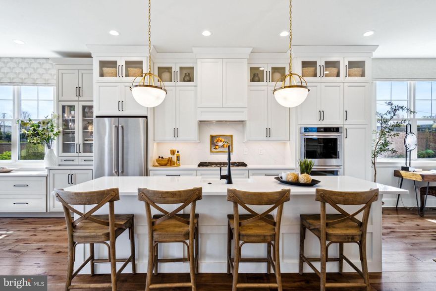 ONE OF THE BEST! End Home with spectacular natural light and just the right amount of space!  The Towns at Newtown Walk is walkable to Whole Foods, Wawa, eateries, restaurants, fitness and shops.  Low maintenance living with a personal elevator for your convenience.   This is a vibrant new construction community that offers a one-of-a-kind floor plan that our homeowners absolutely appreciate.  As you enter the first level into the foyer, notice the convenient 4-stop elevator, coat closet, guest bedroom/office and full bathroom plus a rear 2-car garage and 2-car driveway.  Heading up to the main living level, you'll be blown away by the high 10 ft ceilings and open concept layout.  The kitchen is the focal point with 42" soft close cabinets, quartz countertops and hardwood floors.  Entertain several guests in the beautiful dining area.  Take time to enjoy your hobbies or watch your favorite new shows in the spacious living area with gas fireplace.  The primary bedroom fits a king size bed, large dresser and nightstands comfortably with plenty of room for your clothes and shoe collection in the massive walk-in closet.  Relax and unwind in the ensuite bathroom with walk-in shower and bench, private water closet and double vanity included.  Through the hallway with laundry and linen closet, you'll be led to the second guest suite bedroom and bathroom with walk-in closet. Best of all, the rooftop terrace provides ample outdoor space.  Imagine watching the sunrise with a cup of coffee or even having dinner al fresco.  It even provides area for planter gardening, an optional fireplace or BBQ area.  You will be able to personalize this home and choose tile, flooring, fixtures at the DESIGN STUDIO! The Towns at Newtown Walk is the final opportunity to live at Ellis Preserve and is walkable to shops, restaurants, healthcare.  Easy commute to major roadways, airport, train station and Route 252 & Route 3. This new construction home will be ready for your February 2024 estimated move-in.  Photos are of a decorated model, not the actual home and are for marketing purposes only.