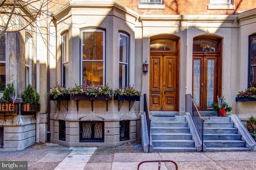This spacious, light-filled, four-story Fitler Square home with vintage mid 19th and 20th century aesthetics, ideal for those seeking a combination of classic charm and modern conveniences in a prime Center City location. The ground floor boasts high ceilings (12'), seamlessly connecting the living, dining, and kitchen areas, creating a spacious and airy feel. Well-appointed oversized eat-in kitchen features a gas fireplace, top-of-the-line appliances (Sub Zero, Thermador, and Bosch), and vintage mid-century design. Abundant natural light on the ground floor from both North and South exposures. The second floor features a primary bedroom suite located at the front of the home. Also on the second floor is a large library or den at the rear. The third floor offers two additional generous bedroom suites, each with its own full bathroom. The fourth floor has two bedrooms with a shared Jack and Jill bathroom. The partially finished lower level features a recreation room with maple floors, knotty pine paneling, a fireplace, wet bar, and half bathroom. This level opens to a north-facing brick-paved rear garden. Three-zone heating and air conditioning with updated and well-maintained mechanical systems. Situated in the Greenfield school catchment, within walking distance of Rittenhouse Square, 30th Street Amtrak Station, and University City.