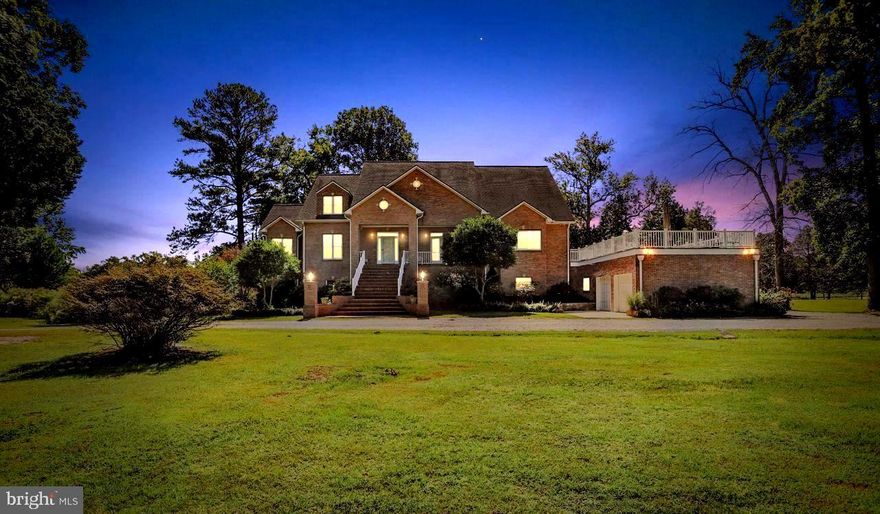 Private Waterfront Estate on 20+ Acres with over 800' of Waterfront includes pier and boat house.  This  secluded estate is surrounded by 100+ acres of protected conservation land.  The  grounds are well manicured with plenty of space for family functions, corporate parties or weddings. The exceptional one of a kind custom built, all brick colonial  home has over 7,000 sq ft of living space and a roof top deck.  There are too many intricate details and custom finishes to list! The main  entrance opens to a spacious two story foyer featuring a Pinnacle curved staircase with imported rails (chandelier has a motorized lift for ease of changing bulbs).  The gourmet kitchen features custom wood cabinetry and two separate cooking stations; Thermador 6  burner propane range with double oven and commercial S/S range hood;  Wolf electric cooktop with commercial S/S  range hood; full size sub zero refrigerator/freezer ; waterfall sink; built-in warming drawer; built-in Miele coffee machine; 3 dishwashers; warming drawer; built-in refrigerator drawers---just to name a few!!  A wine room/wet bar is located off the kitchen with beautiful views of water. The main level also features  separate formal dining room; living room with wood burning fireplace and french doors leading to deck over beautiful serene waterviews; Theater/media room (570  sq ft) includes 7 recliners with space for more. The main level owner's suite  has lighted tray ceiling, atrium door to deck, dual shower, Grohe jetted whirlpool tub and 2 walk -in closets. The upper level features 4 bedrooms, 3  with ensuites.  Finished lower level includes an additional suite perfect for an au pair;  two separate workout/weight rooms; infrared therapy sauna that seats 2-4 people with audio sound; craft  room; music room large enough for a baby grand; family/game room  with pool table, bar and just steps away from patio and hot tub. The kitchenette has multiple cabinets for storage and includes a refrigerator and microwave.
A Generac home generator that automatically delivers electricity during power outage. Also located on the property is  a 30x36 stable/barn with tack room.
Secluded in nature yet easy access to commuting routes to D.C., Baltimore, and  local marinas.