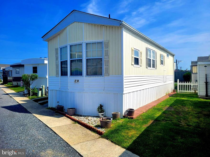 OCEAN CITY LIVING! Well maintained 2-bedroom/2-bathroom home with shower and tub has a private off-street 2-car driveway. Just a short distance to the beach and popular restaurants. Home features open living room/kitchen/dining area, 3 ceiling fans, side-by-side refrigerator with icemaker, dishwasher, built-in microwave, washer/dryer and new flooring and HVAC system! Join this community and live bayside in Warren’s Park. LOW monthly co-op fee of ONLY $150 covers your annual real estate property taxes, public water & sewer fees and also covers management/maintenance of roads, bulkhead, private boat ramp, fish cleaning table/area with running water. Two smaller common areas with steps into the water for fishing, crab pots, clamming & lots more. Use as your year-round, weekend or vacation home.  Selling as is.