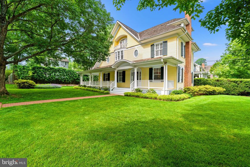 Welcome to this extraordinary residence, where timeless charm meets modern sophistication. Originally a 1920s Sears kit home, this property was masterfully transformed by award-winning architect Mark McInturff. While the traditional exterior maintains its classic appeal, the interior unfolds into an open, light-filled layout with clean lines, modern finishes, and exceptional craftsmanship.

Inside, soaring 9-foot ceilings and maple flooring create a warm and inviting atmosphere. A gracious center hall opens to a sunlit living room with a gas fireplace on one side and a spacious dining room on the other, which flows seamlessly into the custom family room and kitchen. The family room features exquisite maple cabinetry and built-ins, echoing the tone of the maple floors and offering direct access to an expansive 8-foot-deep wraparound porch—ideal for entertaining and everyday enjoyment. The kitchen is outfitted with high-end modern appliances and blends beautifully with the open floor plan. Built-in cabinets extend all the way to the ceiling, providing exceptional additional storage space.

Upstairs, the primary suite is a true retreat, boasting a sunny sitting area, a turret-like vaulted ceiling, generous closet spaces, a gas fireplace, and a spacious bath. A second bedroom—formerly two rooms—offers flexibility, while a hall bath and a BONUS room (ideal for a small office, laundry, or future third bath with existing plumbing) complete this level. See Virtually staged photos. for ideas. The top floor showcases two oversized rooms with vaulted ceilings, window seats, and abundant natural light from a dramatic third-floor skylight. A standout architectural element is the award-winning maple staircase with contemporary cable railing, which visually connects all three levels with elegance and light.

The lower level includes a Refreshed laundry area, Refreshed Storage Room/Playroom, workshop, and ample storage. Outside, the lushly landscaped lot is a private oasis with mature Plane Trees, Astor, Nepeta, and manicured lawn and hardscape—reflecting years of thoughtful care.

Set in the highly sought-after Section 5 of the Village of Chevy Chase, this home enjoys a rare blend of neighborhood charm and walkable amenities, just steps from La Ferme, Brookville Market, local shops, and two prestigious private clubs. Its location offers convenient access to both downtown Bethesda and Washington, D.C.—an exceptional opportunity in a truly magical setting.