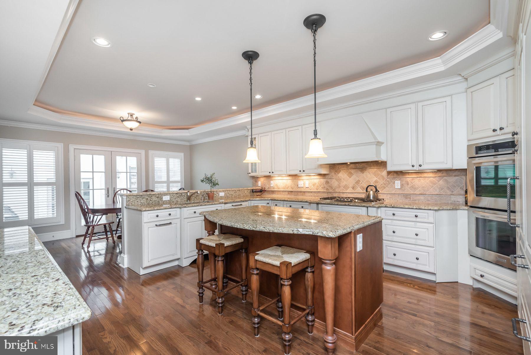OPEN HOUSE SATURDAY, MARCH 30TH, 12 - 2 PM! Wonderful opportunity to live close to everything Canton/Brewers Hill has to offer! 3,600+ SF OF LIVING SPACE, PRIVATE PATIO, GARAGE, & ROOFTOP DECK! This custom-built, double-width, brick row home boasts a traditional aesthetic with meticulous mill-work, impressive attention to detail, and a well thought out floor plan; ideal for entertaining with built in speakers throughout or privacy & relaxation among the separate living quarters. Highlights of the main floor include a large exposed-brick living room and a stunning gourmet kitchen with custom cabinetry and tile work, granite countertops, built-in Sub-Zero refrigerator/freezer, double ovens, double built-in dishwashers, wine cellar, eat-in island and breakfast bar, and an additional breakfast room space with French doors that invite you out to a private hardscaped bluestone terrace featuring a fieldstone seating area and with built-in grill; absolutely perfect for summer happy hours or snowy winter barbeques around the outdoor fireplace. Beyond the patio is the detached garage with a 15 ft. lofted ceiling ideal for a car lift or additional storage. The garage is simply an added bonus as parking is abundant on this quiet tree-lined street. As if that isn't enough, this remarkable home also offers 4 bedrooms, all with en suite baths; TWO master bedrooms, with oversized dual-vanity bathrooms extending the full width of the home, and a convertible basement bonus room/guestroom with a must-see wet bath. Most notably though, is the 3rd floor Owner's Retreat encompassing the entire floor and featuring an expansive sunny sitting room with built-in kitchenette; a dream for morning coffee or a night-cap! The coffered ceiling rivals the impressive custom walk-in closet as the highlight of this master bedroom, as the custom bathroom suite exudes relaxation with a jetted tub, mounted 37 in. TV, 8 ft. shower-head walk-in rain shower, in addition to the granite double vanity. Up just one more flight, the 4th floor roof deck encompassing the length of the house showcasing 360 degree views of Baltimore's iconic gems: water views of the harbor, city skyline, Ft. McHenry, and Natty Boh Tower. Once again street side, you'll find Canton Crossing Shopping Center, Merritt Club & rooftop pool, Canton Dog Park, and the picturesque Canton Waterfront Park and Promenade all just an incredible 2 blocks away and access to I-95/895 beyond convenient. This is the epitome of "the best of both worlds:" the space and quality of a sophisticated house and the convenience and accessibility of city living. This home is simply not to be missed.