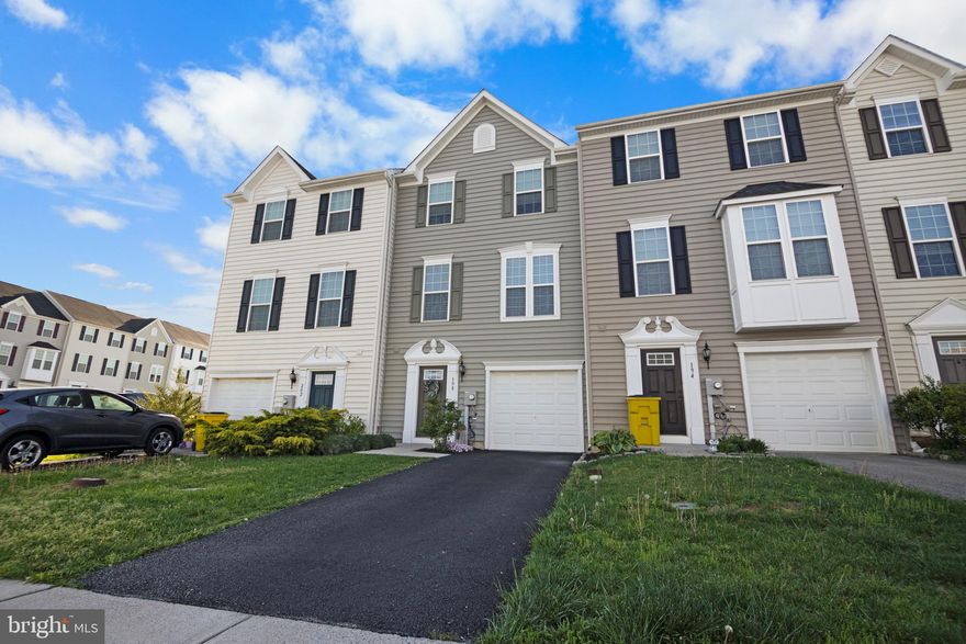 Constructed in 2016, this inviting three-level townhome is situated in the sought-after Potomac Station neighborhood, just minutes from Spring Mills. Offering convenience and close proximity to schools, stores, and restaurants, this residence boasts nearly 2,000 square feet of finished living space, combining both comfort and functionality. The entry level features a half bath, laundry closet, carpeted recreation room, and access to the attached garage. The main level showcases an open concept kitchen and living room. The kitchen is equipped with luxury vinyl flooring, stainless steel appliances, an above-the-range microwave, center island, and a sliding door leading to the sizable fenced backyard. The connecting living room offers ample space, luxury vinyl flooring, and large windows. On the upper level, you'll find three carpeted bedrooms and two bathrooms. The primary bedroom features a spacious walk-in closet and a connecting primary bathroom with a double vanity sink, brushed nickel faucets, and a stand-up shower with dual shower heads. Down the hallway are the remaining two bedrooms that share a sizable full bathroom. In excellent condition and move-in ready, this townhome is sure to go quickly. Schedule your showing today to see all it has to offer!