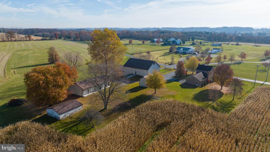 This property is a 74+ acre farm with numerous outbuildings. Among these structures is a spacious 40 X 60 barn featuring a hay loft and a sliding bay door on the 30 X 40 addition, as well as a 4 bay garage with an additional 10 ft bay, perfect for accommodating an RV. Additionally, there is a separate 1 car garage equipped with electricity. The property also includes approximately 60 acres of tillable land, currently leased, making it an ideal investment for those seeking agricultural ventures. All the outbuildings are meticulously maintained, featuring durable metal roofs and siding. Whether you have farming equipment or farm animals, this property offers the perfect setting to fulfill all your agricultural needs. The farmhouse itself exudes charm and character, with bamboo flooring and wide plank hardwood flooring throughout. The kitchen has been updated and includes a dining area, while the first floor also boasts an office and a cozy living room with a wood burning fireplace and exposed wooden beams. This is the prefect place whether you are looking to accommodate  your farm equipment/animals or an agricultural hobbyist looking for a private and peaceful place to live!