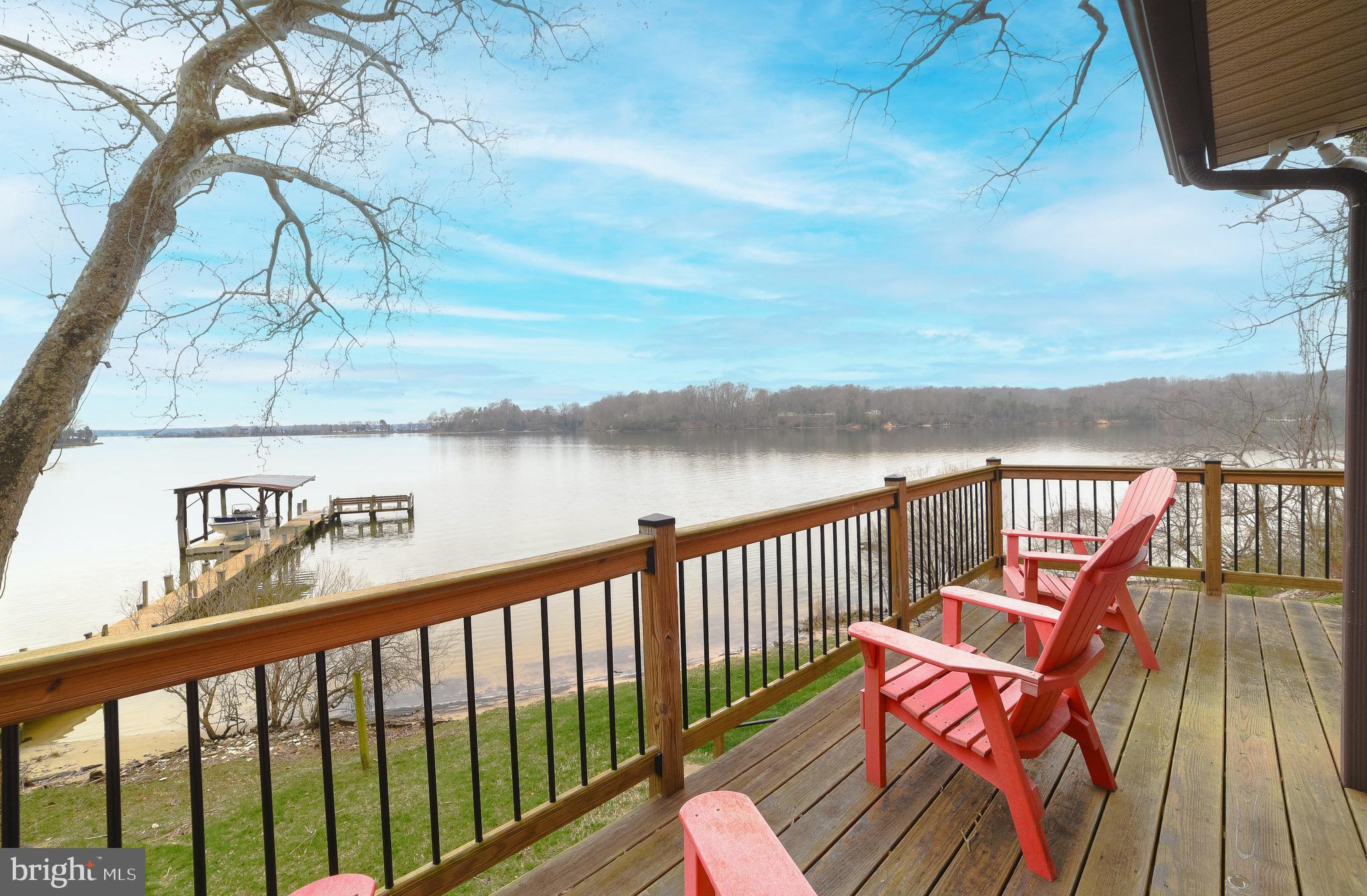 Waterfront on Battle Creek with sandy beach, pier, lift and COVERED BOAT SLIP!!! . Four Bedrooms/ Three full baths. One acre of privacy.
Amazing views up, down and across the Creek, with views out to the Patuxent River. Perfect gentle slope to the water. IF you enjoy boating, kayaking, paddle boards, crabbing and fishing off of your own pier... toes in the sand, Do NOT hesitate!! Need to get away from the hustle and bustle of life... this is the perfect quiet, peaceful private location.
Open floor plan with walls of glass to capture the views. Living area is just the right size for friends and family. Open kitchen with granite countertops, stainless appliances, wine refrigerator. Primary bedroom with gorgeous views from your pillow! Walk in shower, whirlpool tub. Two additional bedrooms with hall bath.
Lower level features Rec Room area, 4th bedroom -- All with water views, full bath, storage and walk out to the water. Decking and stone patio area offer lots of space for relaxing, outdoor dining and gorgeous sunsets. Play ground equipment for children conveys. Fire pit with lots of firewood ready and waiting for you. Paved driveway. MLW per Navionics is 3-4 ft
New roof in 2018. French drain installed in past few years by Bennett Waterproofing. Shared well with adjoining property, recorded agreement in documents, Well sits on this property.
Recorded driveway easement and maintenance agreement in documents.
Being sold AS IS. Furniture, kayaks, SUPs, paddle boat are negotiable if Purchaser is interested, all also as is.
Ideal for full time living or weekend escape. Everything is in place and ready for a new owner to move in and enjoy, just as boating season begins!! Priced to sell!!!
