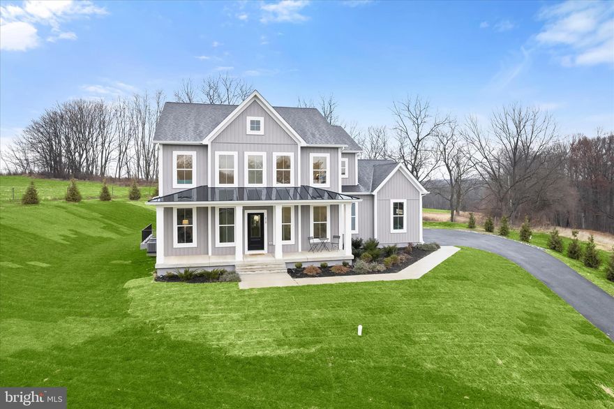 Introducing this exceptional brand new Somerset model by Greenspring Homes set on a 3.1-acre lot at the end of a long private drive. Offering four bedrooms and two and a half bathrooms, this move-in ready home showcases high-quality finishes throughout. As you arrive, the property welcomes you with a covered front porch and an oversized two-car garage. Inside, a modern neutral palette, tall ceilings, and abundant natural light create an inviting atmosphere. The foyer opens to beautiful hardwood floors, with a versatile front office that could also function as an additional lounge space. The formal dining room is adorned with a tray ceiling with crown molding, and a butler’s pantry with a walk-in pantry that connects to the kitchen. Stunning coffered ceilings in the living room and kitchen add elegance, with a gas fireplace being added to the living room. Prepare your favorite meals in the gourmet kitchen that is fully equipped with stainless steel appliances, quartz countertops, a tile backsplash, soft-close shaker cabinetry, a center island, and a breakfast nook for casual meals. Finishing the main level is a half bathroom, a mudroom with built-in cubbies and access to the garage. Upstairs, the primary bedroom suite awaits with two walk-in closets and a luxurious bathroom featuring a dual-head walk-in shower, soaking tub, double vanity, linen closet, and separate water closet. The second and third bedrooms both have walk-in closets, with a fourth bedroom, shared hall bathroom and a convenient laundry room completing this level. The unfinished walkup basement awaits your personal vision, offering rough-in plumbing for an additional bathroom and ample space for future rooms. Enjoy exceptional modern living in this brand-new home designed with comfort, style, and functionality in mind.