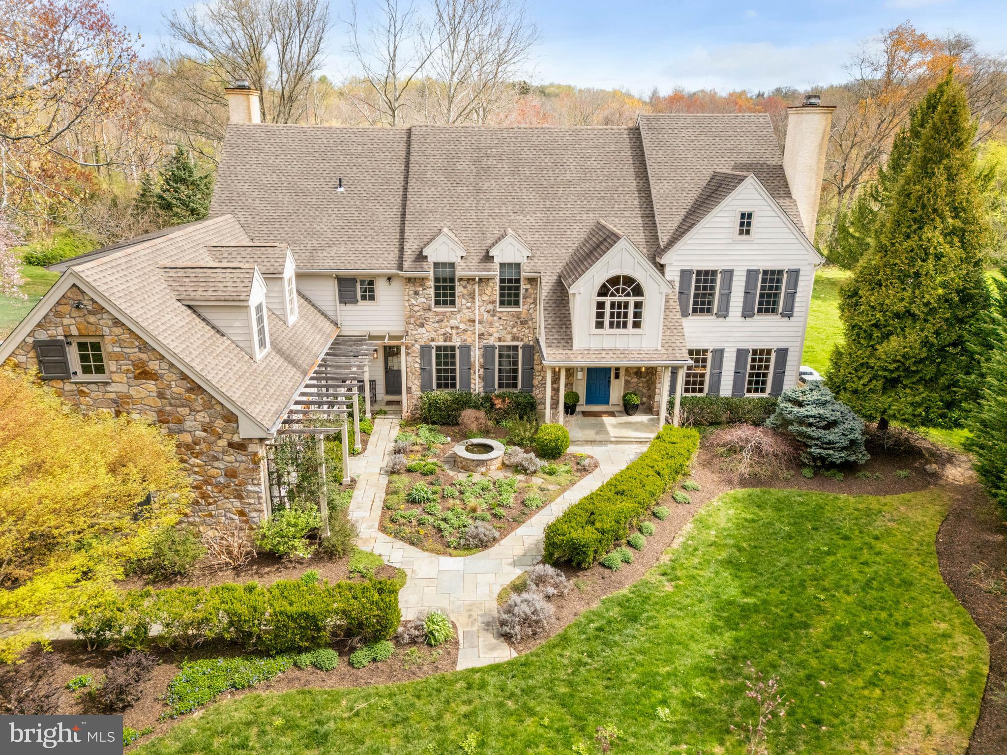 Nestled in the heart of Berwyn, Easttown Township, this special residence at 607 NEWTOWN ROAD offers privacy, elegance, luxury and comfort. Situated on nearly 2 bucolic acres of landscaped grounds, wonderful views, and gardens, this beautiful 5 Bedroom | 4 Full and 2 half bathroom Stone and Hardie plank siding home provides a welcoming presence from the street. As you approach the front entrance, you will be greeted by inviting gardens, architectural details, and a soothing water feature. The Front-to-Back Entrance Foyer greets you flanked by a formal Living Room with a handsome wood burning fireplace to your right, and a formal Dining Room to your left, setting a refined entertaining tone. A Formal Powder room is at the rear of the entrance foyer. The well-appointed Office/Study, with custom built-ins with a bar, hidden tv, and bookcases, offers a quiet, private space for working from home. Continuing on the main level, the updated, Gourmet Kitchen opens to the Breakfast Room and the grand Family Room with soaring ceilings, walls of large windows and a cozy, stone gas fireplace with flagstone hearth and built-ins. Highlights of the kitchen include a Wolf gas range with double ovens, six-burners and a griddle; a SubZero Refrigerator with refrigerator drawers; a SubZero Freezer with freezer drawers; a SubZero wine refrigerator; a large island with granite counters, a built-in combined microwave/convection oven, a warming drawer, additional storage and room to sit and enjoy special family moments together; a coffee bar area with sink; custom cabinetry and Soapstone countertops providing ample storage for cookbooks, specialty appliances and serve ware. The mudroom provides direct, interior access from the 3-bay garage equipped with a proper outlet to charge your Electric Vehicle; the laundry room; the informal powder room; a command center with built-ins and a rear staircase to the 2nd level. The wide staircase in the entrance foyer leads you to the sun-filled landing and the second floor. Upstairs is the Primary Bedroom with a cathedral ceiling, an adjacent dressing room with custom closets and flex space, two walk-in closets and an en-suite bathroom with dual sink areas, a separate shower, a jetted tub, and a water closet with a Toto washlet toilet; bedroom # 2 with an en-suite and hallway access bathroom; Bedroom # 3 and Bedroom # 4 with a Jack-and-Jill bathroom; Bedroom # 5 with built-ins and a bonus room to suit your unique need; a built-in study area in the hallway; and walk-up access to the large, unfinished attic that could be finished for your additional living needs. The large, daylight, finished, lower level offers additional living and entertainment space featuring built-ins, a home entertainment area with wall-mounted tv; a full bathroom with shower; utility area and storage areas including wine storage. Enjoy outdoor gatherings this summer with family and friends on your large, private deck, with a covered section, and a flagstone patio all overlooking the beautiful, private grounds. The home was pre-inspected. Enjoy additional security and peace of mind with the gas generator for those inclement days. This home is located in the highly sought-after Tredyffrin-Easttown School District with convenient access to major arteries; shopping and dining in Paoli, Berwyn, Devon and Newtown Square; and Hilltop Park. 607 NEWTOWN ROAD is ready to welcome its next owners as it delivers an elevated, suburban lifestyle perfect for family and entertaining. Don’t miss the opportunity to make this your new home schedule your private appointment today!