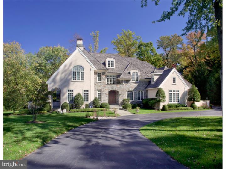 This exceptional English Manor home was built by C.F. Holloway & sits on 1.27 acres of picturesque grounds; features 6 bedrooms, 6 full bathrooms, 3 powder rooms, 3 fireplaces, a 3-car attached garage & a wonderful array of luxurious amenities. With over 8,000 square feet of well-designed living space, this home is both grand & comfortable with great flow for living as well as entertaining. The craftsmanship & architectural elements show great attention to detail with true luxury in mind. The home's exterior is elegant with stone & stucco featuring a covered front entry with dark mahogany door & leaded glass sidelights. The main floor features a 2-story Grand Entrance Hall with a limestone floor, sweeping staircase & a walk thru Center Hall. The Dining Room has a coffered ceiling & wainscoting; the Living Room has a fireplace, bay window & French doors to a handsome cherry-paneled Library/Office with built-in cabinetry, fireplace & French doors to a flagstone patio. The Family Room has built-in cabinetry, stone fireplace & large picture windows. The spacious gourmet Kitchen includes Wood-Mode cabinetry & top-of-the-line appliances. The Breakfast Room, with a vaulted ceiling, opens onto a screened Porch & large Deck. An expansive Master Bedroom Suite with Sitting Room plus four additional Bedrooms occupy the second floor. The daylight, walk-out Lower Level comprises a Family Room, Recreation Room, 6th Bedroom/Exercise Room, a full Bathroom & great storage.